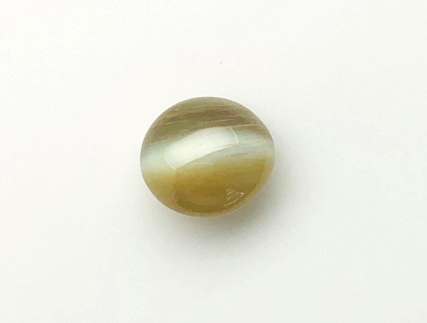 This gorgeous, 6.66 carat cat’s eye chrysoberyl is a real gem and would make a stunning ring!! It exhibits a textbook crisp, bluish white eye and the highly prized “milk and honey” effect. It has rich, even body color, excellent translucence, and a