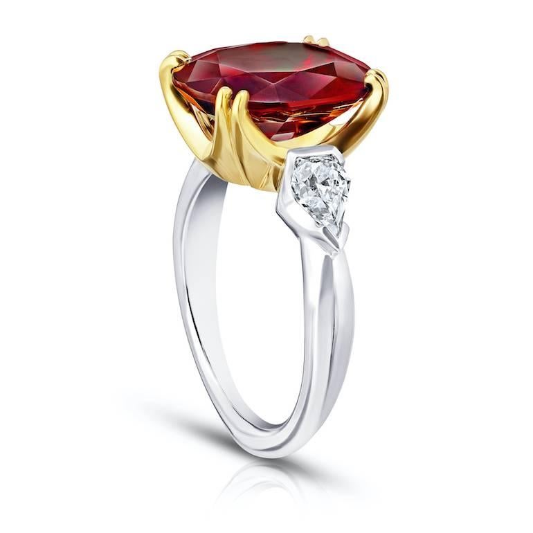 6.66 oval red spinel with two shield shaped diamonds weighing .80 carats set in a platinum and 18k yellow gold ring
