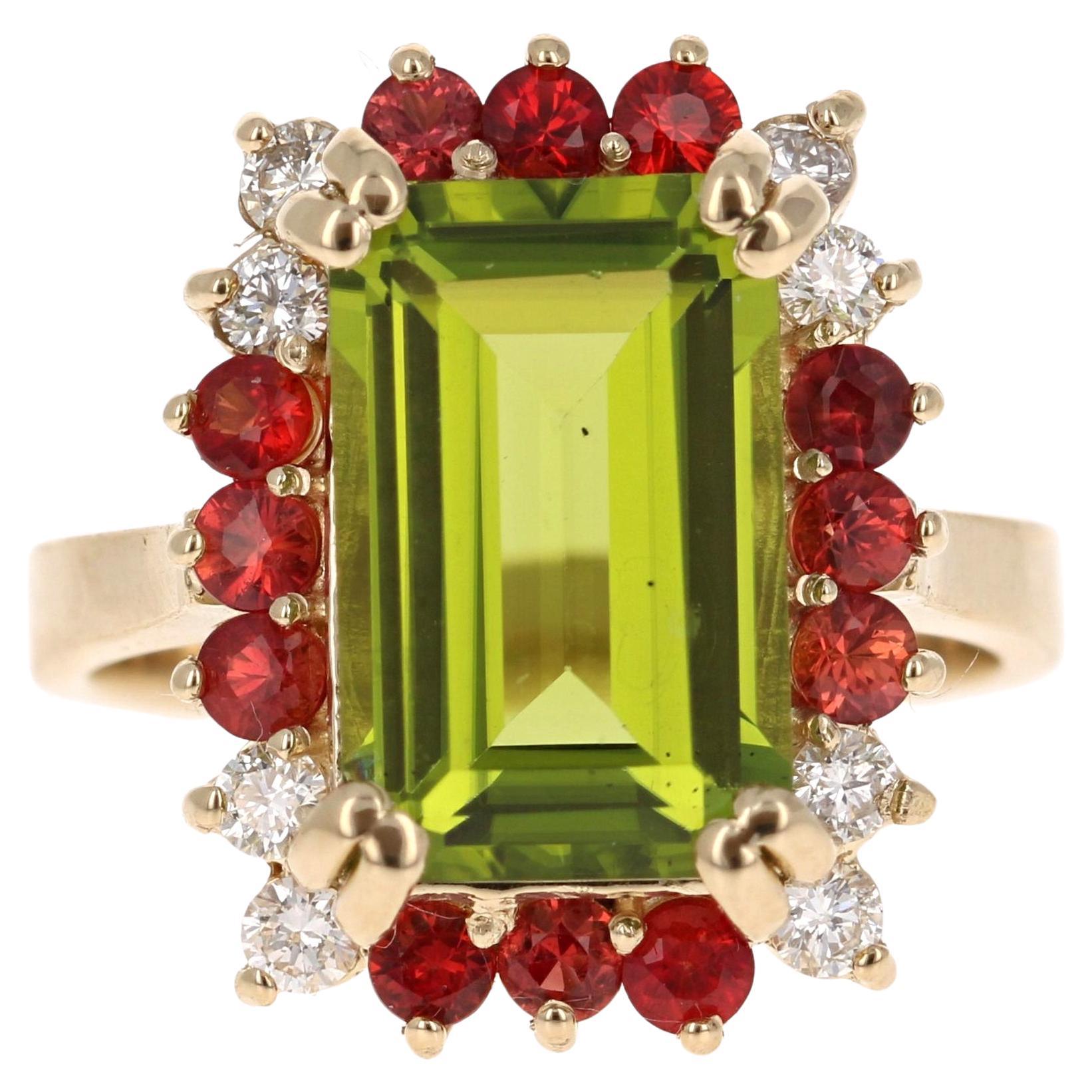 6.67 Carat Emerald Cut Peridot Sapphire and Diamond 14 Karat Yellow Gold Ring -  the perfect ring for the holidays!!  The red and green stones are so festive for the upcoming season!!

This beautiful ring has an Emerald Cut Peridot that weighs 5.32