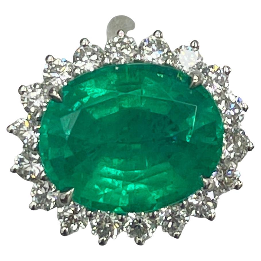 This is a LIVELY emerald mined in Brazilian. It is very saturated. This emerald has a pleasant and happy color and mounted in a simple platinum ring with 1.13carats of brilliant white diamonds.