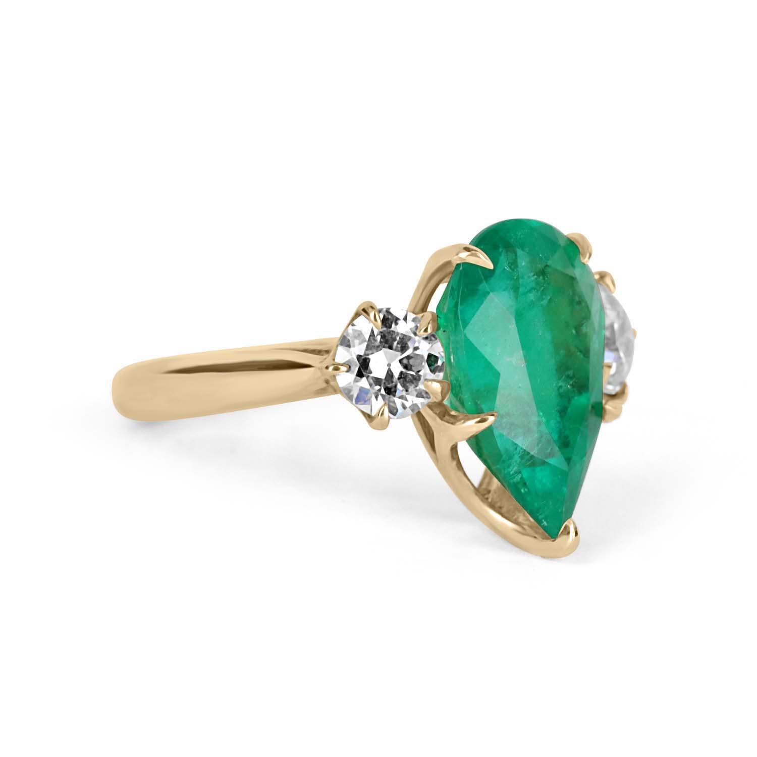 A stunning natural Colombian emerald and diamond three-stone ring. At the center is displayed a magnificent 5.74-carat natural Colombian pear cut emerald with vivid green color and visible Jardin and imperfections, making this stone a one of a kind.