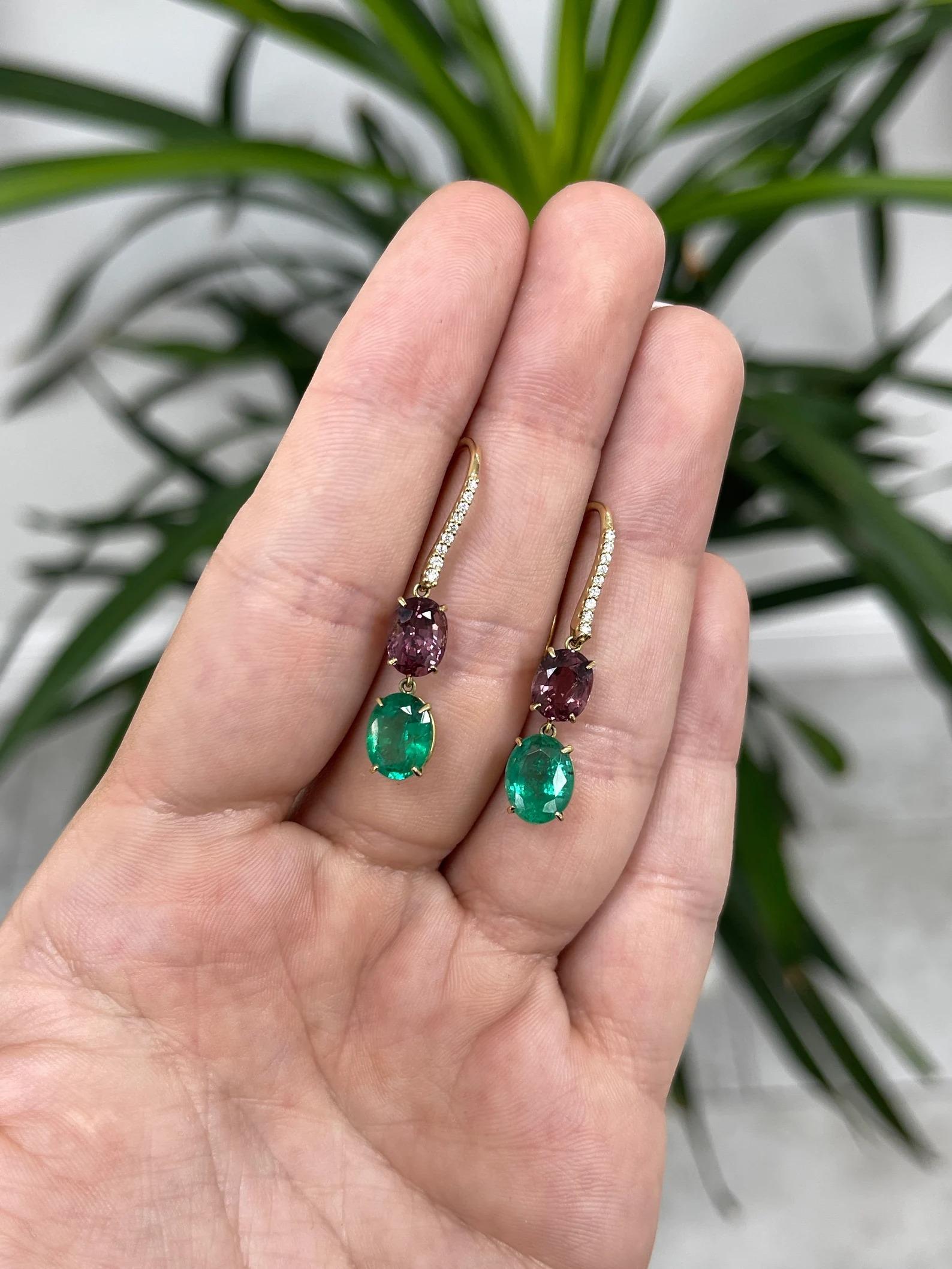 An astounding pair of natural emerald, spinel, and diamond dangle ear wire earrings. The oval-cut emeralds carry 3.85-carats in total; displaying a medium-dark green color, very good luster, and clarity. Above is a gorgeous couple of natural spinel.