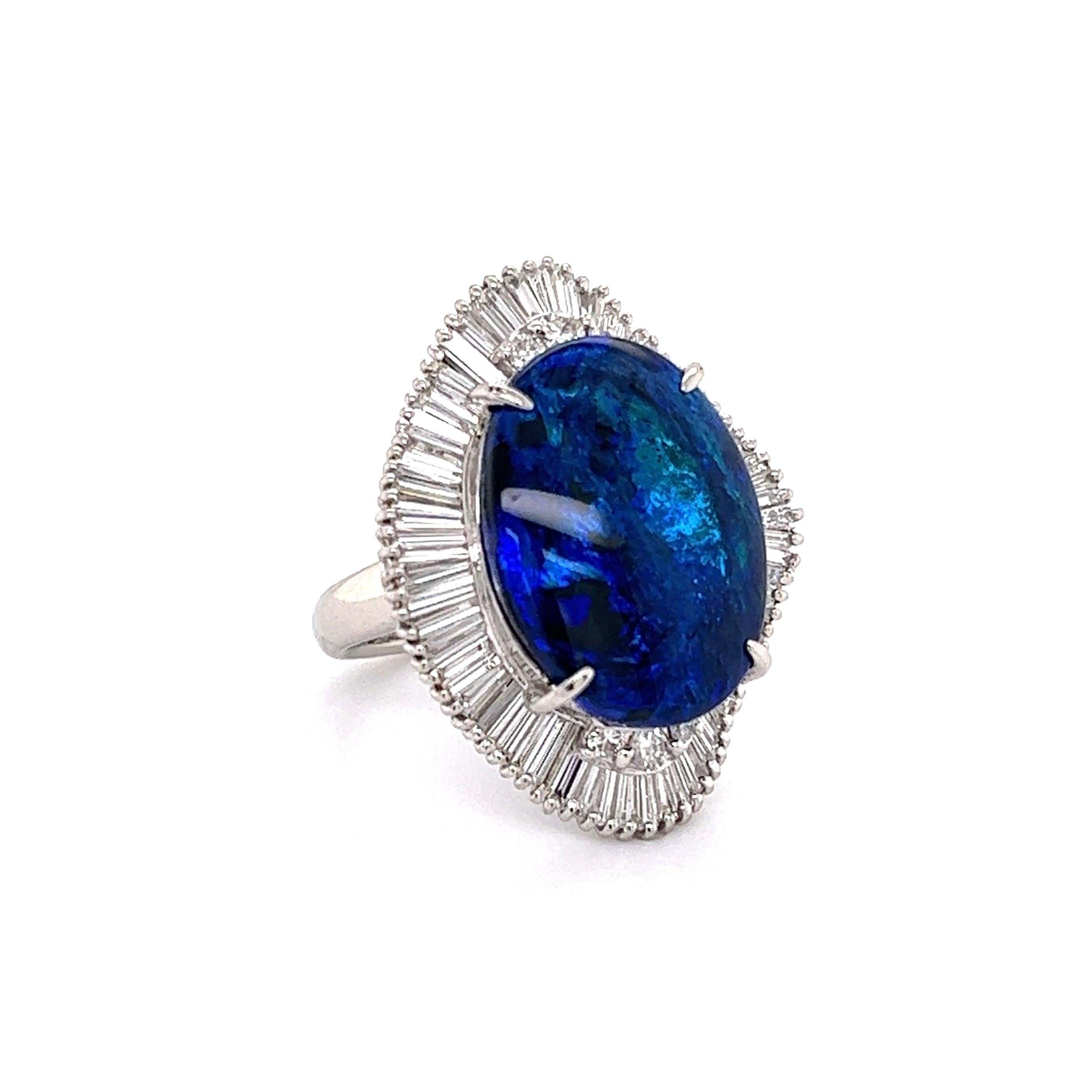 Simply Beautiful! Black Opal and Diamond Cocktail Ring. Centering by a 6.69 Carat Oval Black Opal, surrounded by Diamonds, weighing approx. 1.40tcw. Finely detailed Hand-crafted Platinum mounting. Approx. Dimensions: 1.01” l x 0.84” w x 1.08” h.