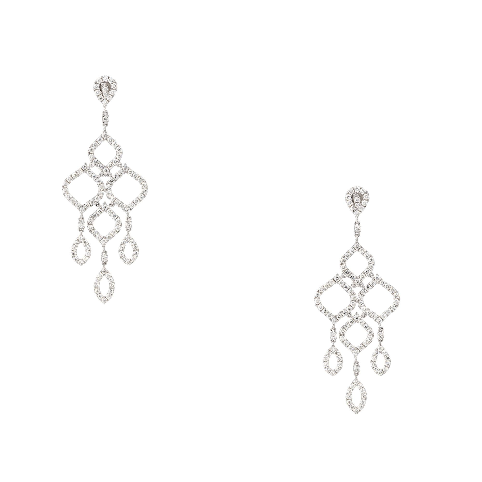 18k White Gold 6.69ctw Round Brilliant Diamond Open Chandelier Drop Earrings
Material: 18k White Gold
Diamond Details: The diamonds are approximately 6.69 carats of round brilliant cut diamonds. All diamonds are approximately F/G in color and