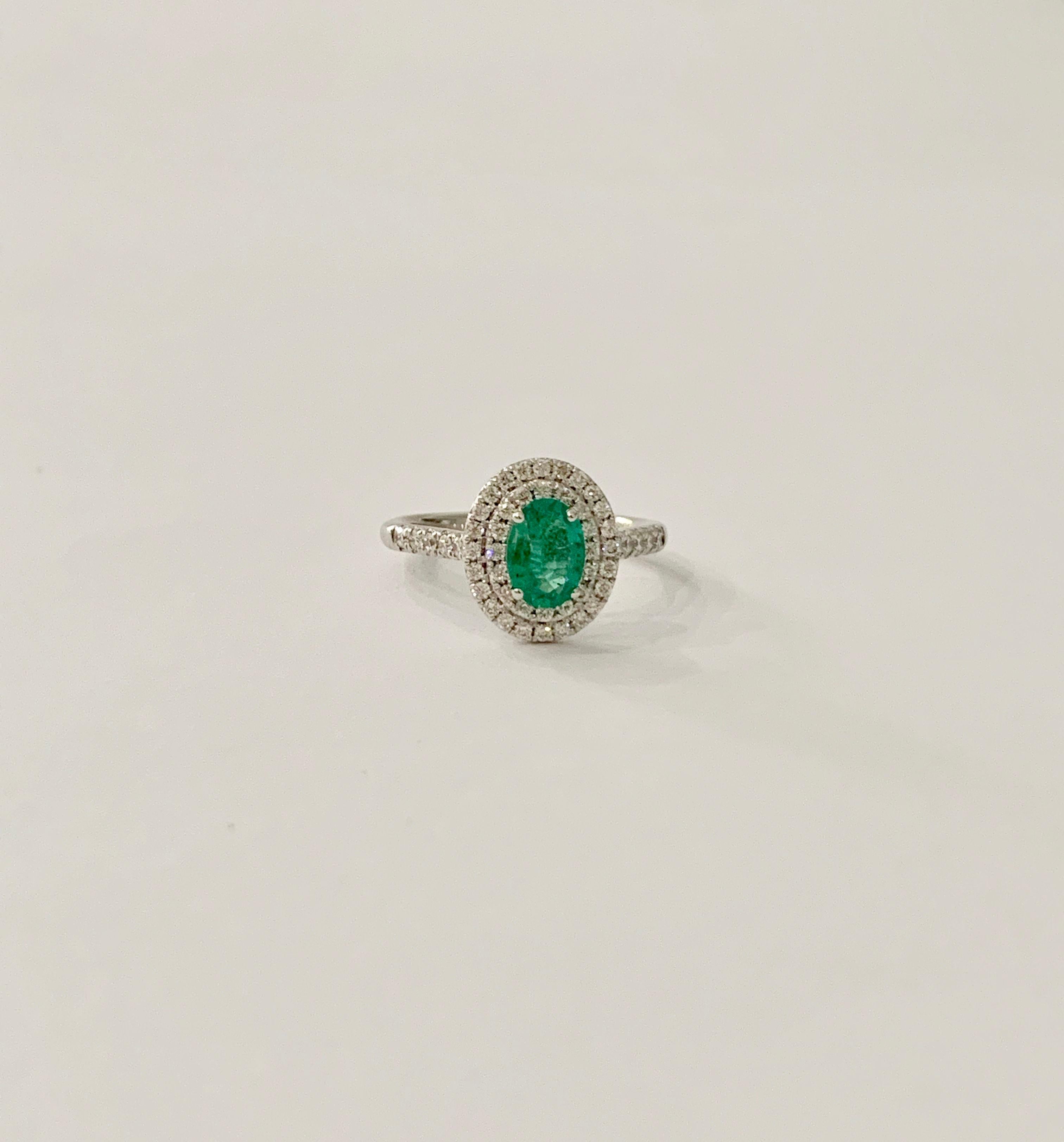 This stunning AAAA Oval Emerald is of a bright green colour which is set off spectacularly by the double halo of diamonds.  The ring could make an amazing Engagement ring but would just as well make a beautiful Cocktail RIng.  The 0.66ct Emerald