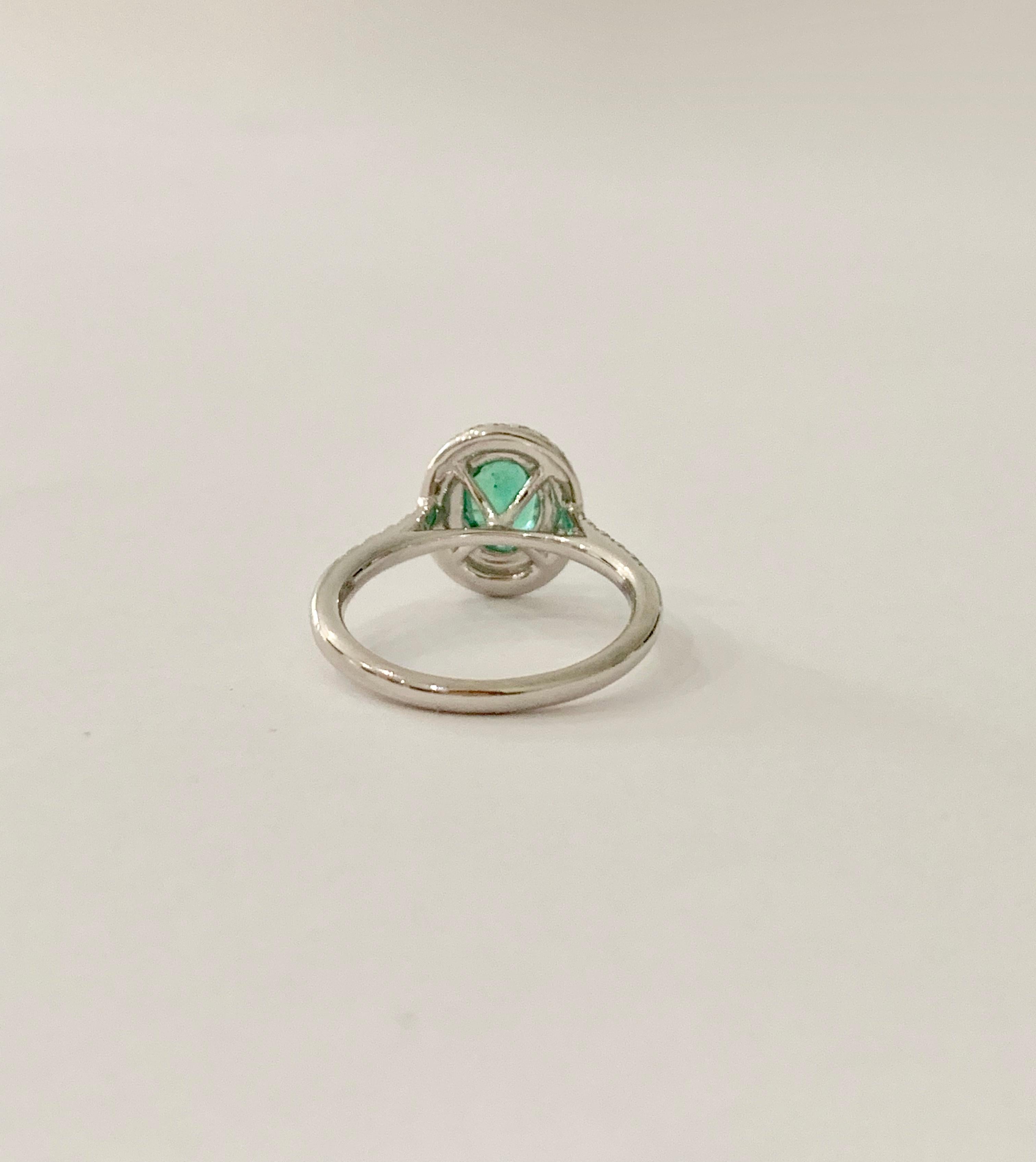 Modern .66 Carat AAAA Oval Emerald Set in Double Diamond Halo Ring in 18ct White Gold For Sale