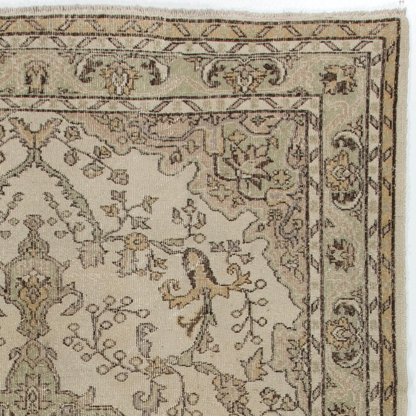 Un tappeto turco vintage finemente annodato a mano degli anni '60 e caratterizzato da un disegno a medaglione in colori neutri. Il tappeto ha un vello di lana basso su una base di cotone. È pesante e si appoggia sul pavimento, in ottime condizioni e