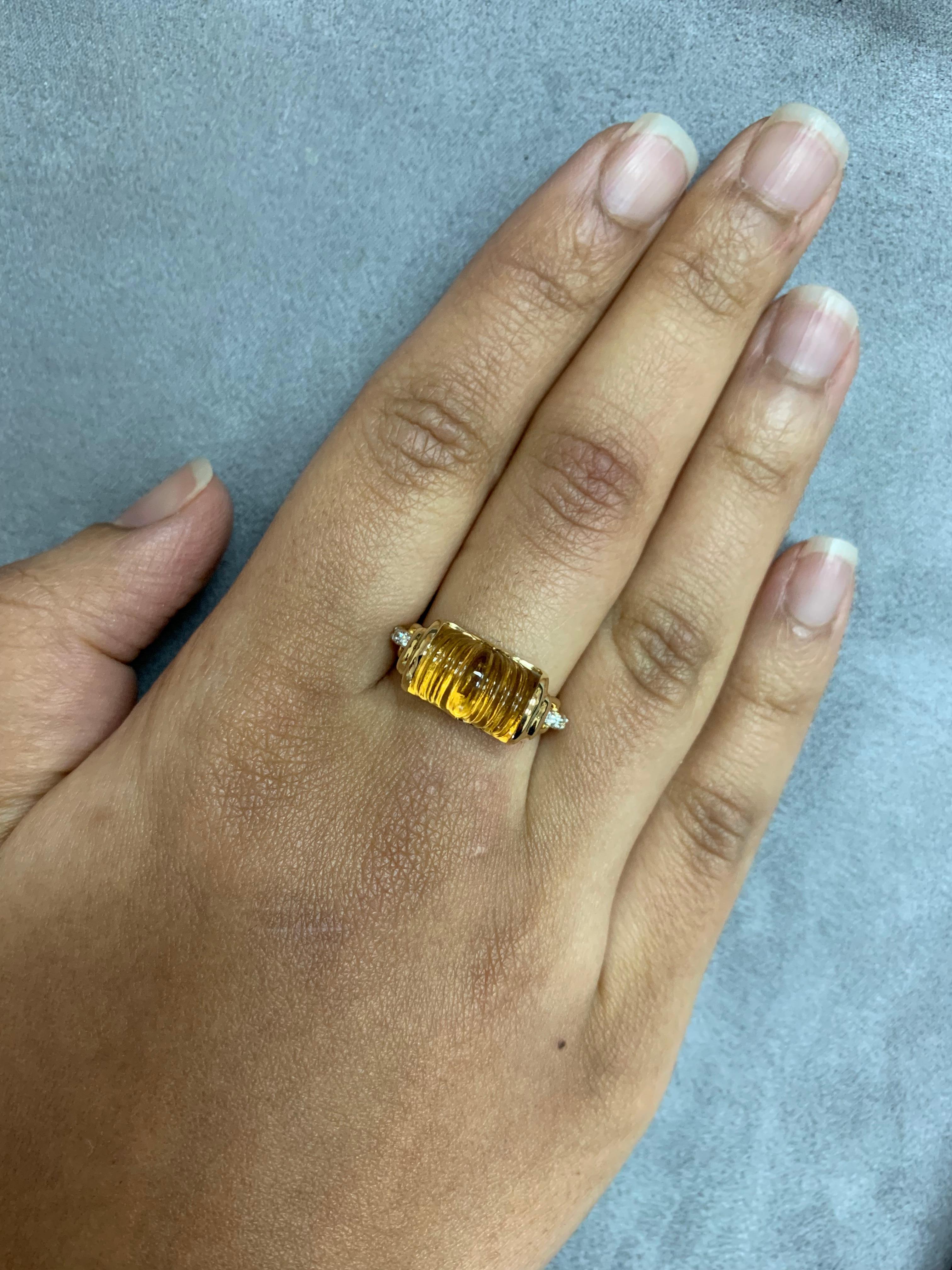 Sunita Nahata presents a collection of bold and colorful cocktail rings. This ring features a unique carved citrine at the center, with diamonds accenting the 18K yellow gold.  

Carved Citrine Ring with Diamond in 18 Karat Yellow Gold

Citrine: