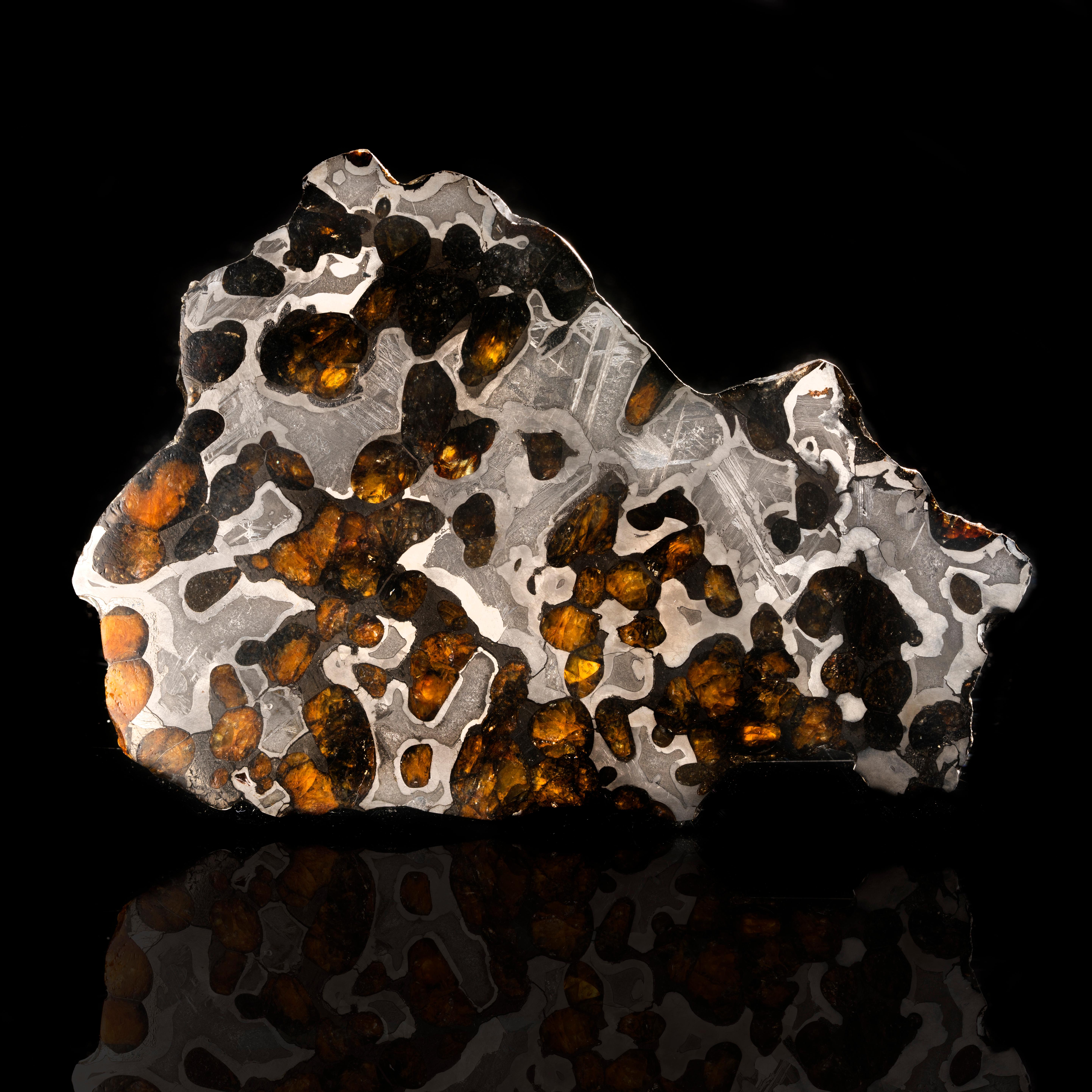 The Brenham meteorite is a pallasite meteorite found in Kansas in 1882. It is one of only a few pallasite meteorites, a type of meteorite with beautiful green and orange olivine crystals growing within a coarse octahedrite stony-iron pattern.