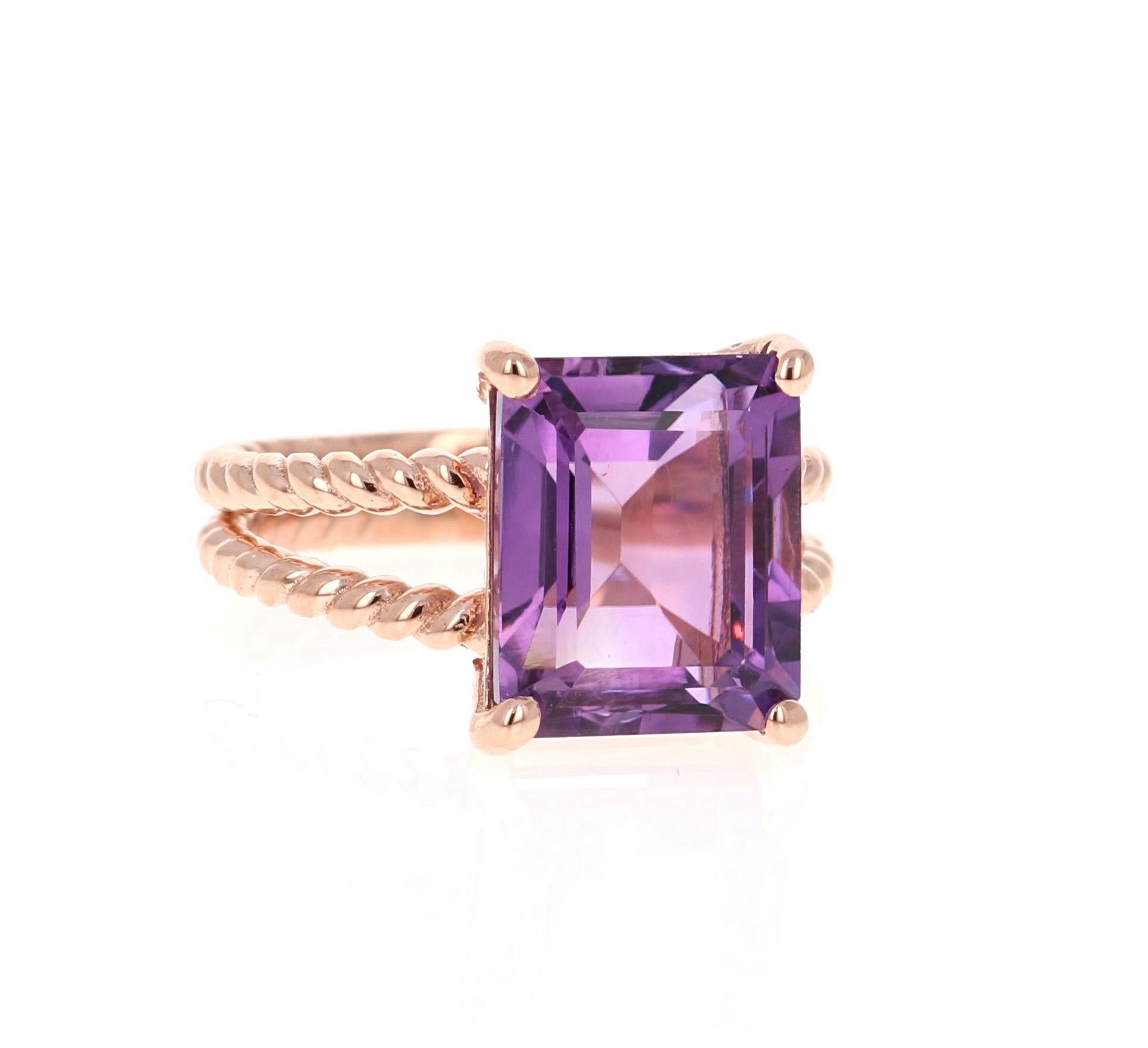 This Designer inspired Ring has a bright and vivid Emerald Cut Amethyst in the center that weighs 6.70 carats. 
The setting is beautifully crafted in 14K Rose Gold and weighs approximately 5.0 grams.
The ring is a size 7 and can be re-sized if