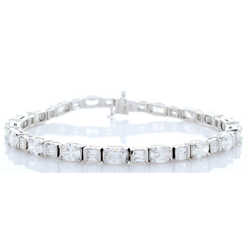 Stunning, yet delicate and simple. Tennis bracelets always provide a timeless and elegant look. This one however stands out with exceptional sparkle. Featuring 5.64 carats of oval F,G/VS diamonds and 1.05 carats of baguette cut F,G/VS diamonds, this
