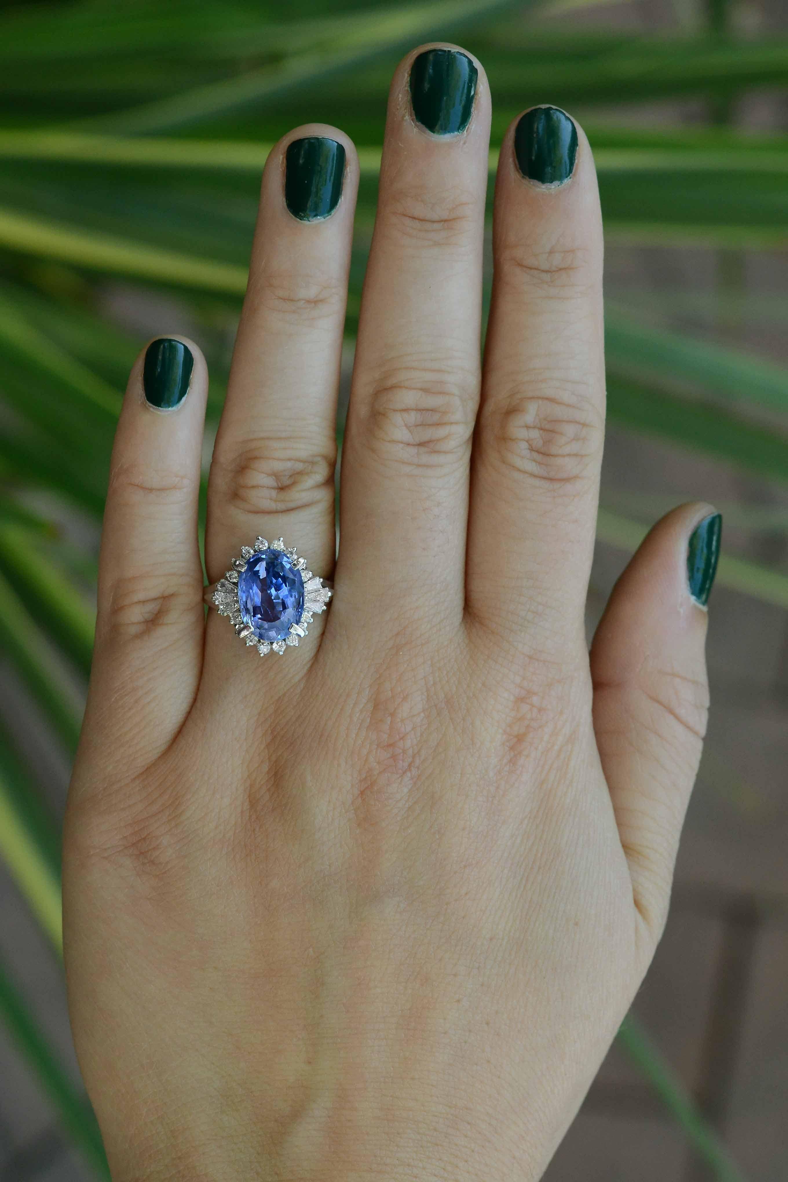 This captivating ring headlines a sizable sapphire that portrays an eye-catching violet color. This uniquely colored gem is set in a ballerina setting that puts on a graceful and elegant show. The baguette diamonds taper and flow into a curve of