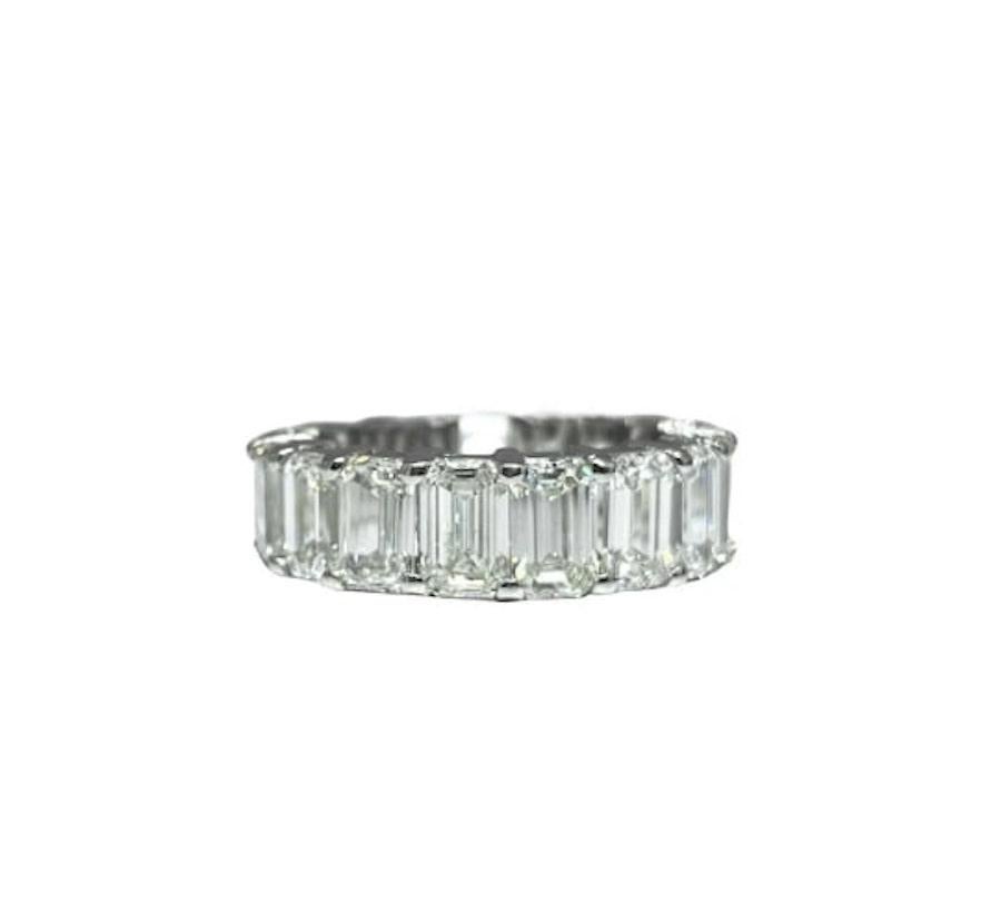 This stunning band features 20 natural emerald cut diamonds weighing 6.71 ct total weight and graded E-F in color and VVS2-VS1 in clarity. Each stone roughly measures 5mm by 3 mm giving a much larger appearance. This ring has been handmade in