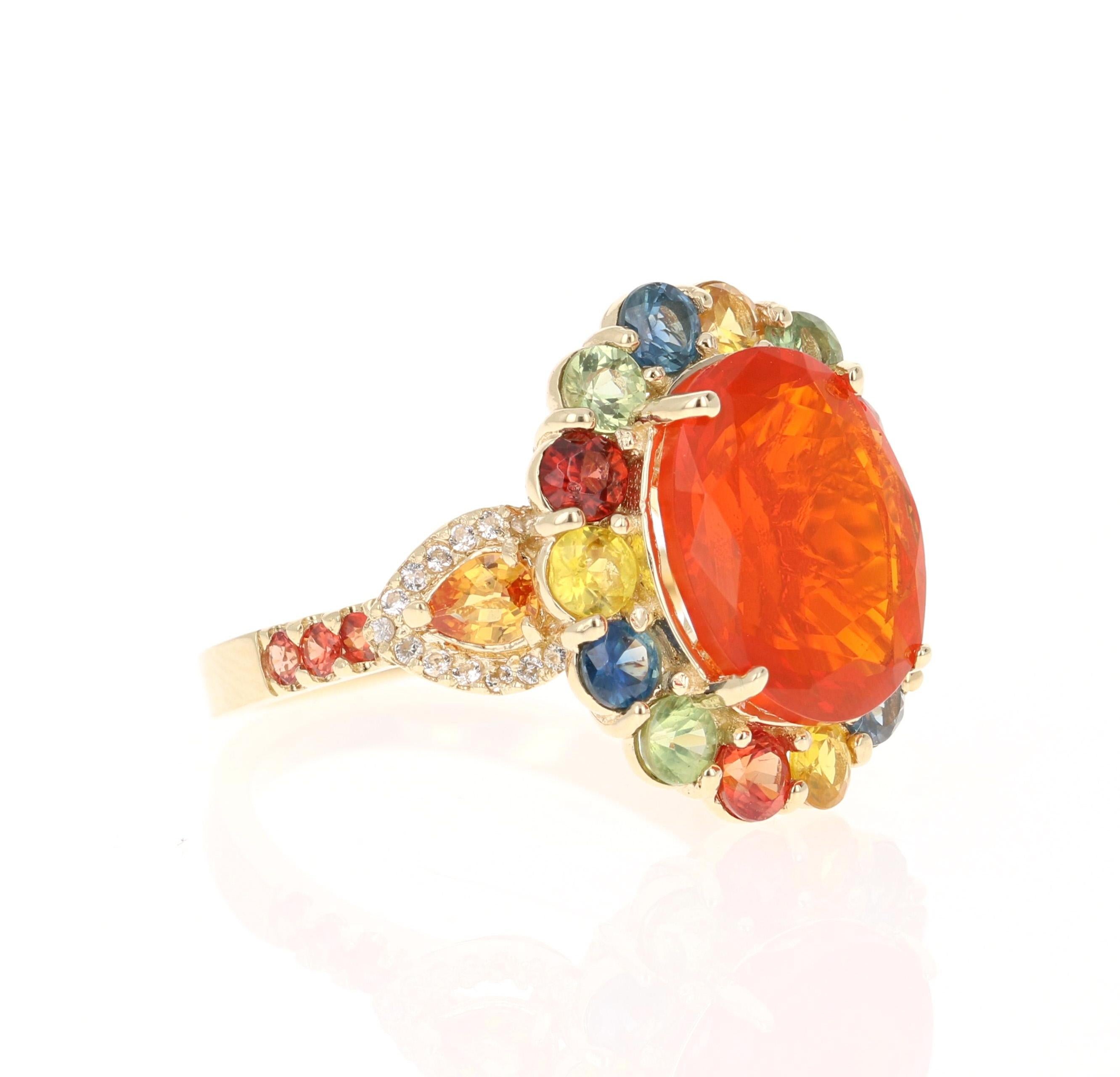 This ring has a 3.94 carat Oval Cut Fire Opal as its center stone and is elegantly surrounded by 22 Multi-Colored Sapphires that weigh 2.62 Carats and 30 Round Cut White Sapphires that weigh 0.16 carats. The measurements of the Fire Opal are 10mm x