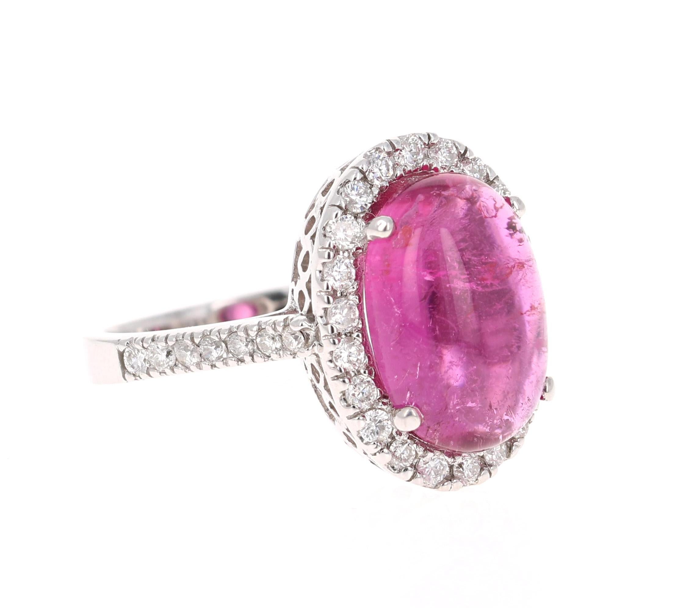 This ring has a simply gorgeous Oval Cut/Cabochon Pink Tourmaline that weighs 6.10 Carats. Floating around the tourmaline is a simple halo of 36 Round Cut Diamonds that weigh 0.62 Carats. The total carat weight of the ring is 6.72 Carats. 

This
