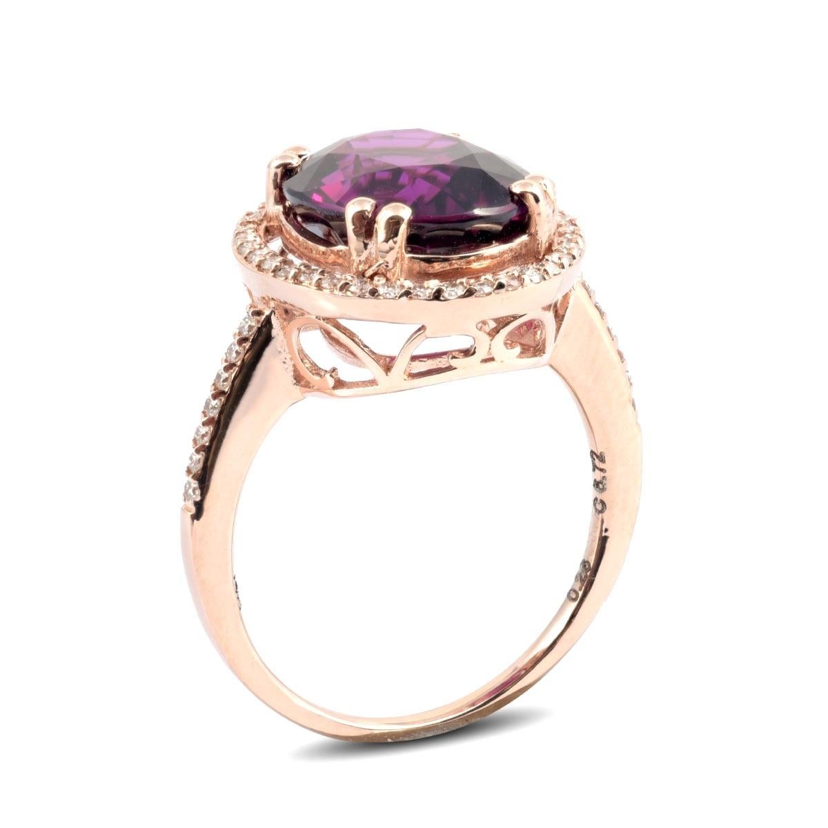 A bold and beautiful piece, this statement grape colored Garnet ring will surely be a forever favorite. Set in the complementing 14K rose gold, and with perfectly matched diamonds around at 6.72 carats it is an apt size. Just right for a woman who