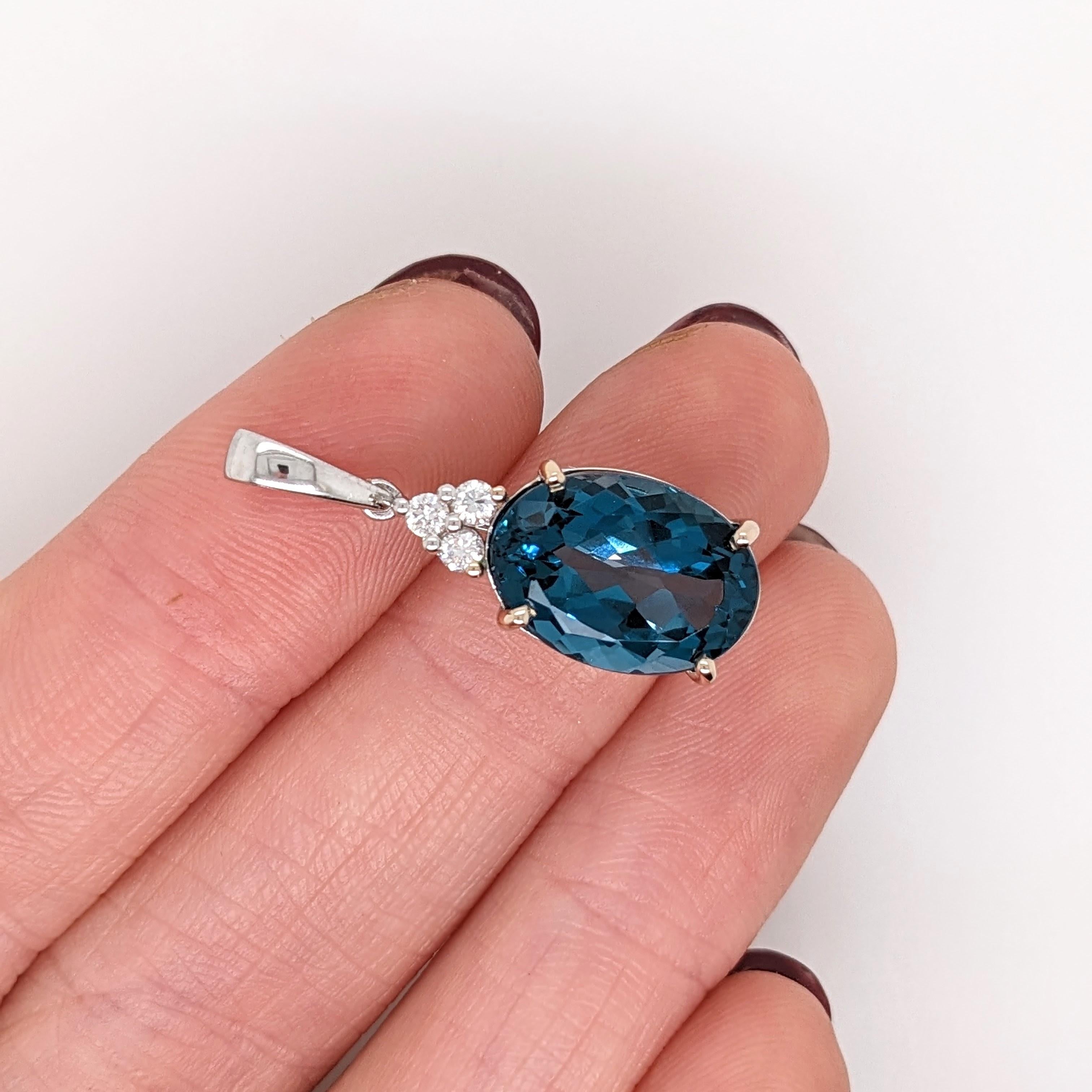 This London Blue Topaz pendant features a gorgeous unique shade of vibrant blue and beautiful clarity with an amazing sparkle. This pendant makes a stunning statement piece made in 14k white gold with a triad of natural earth-mined diamonds that