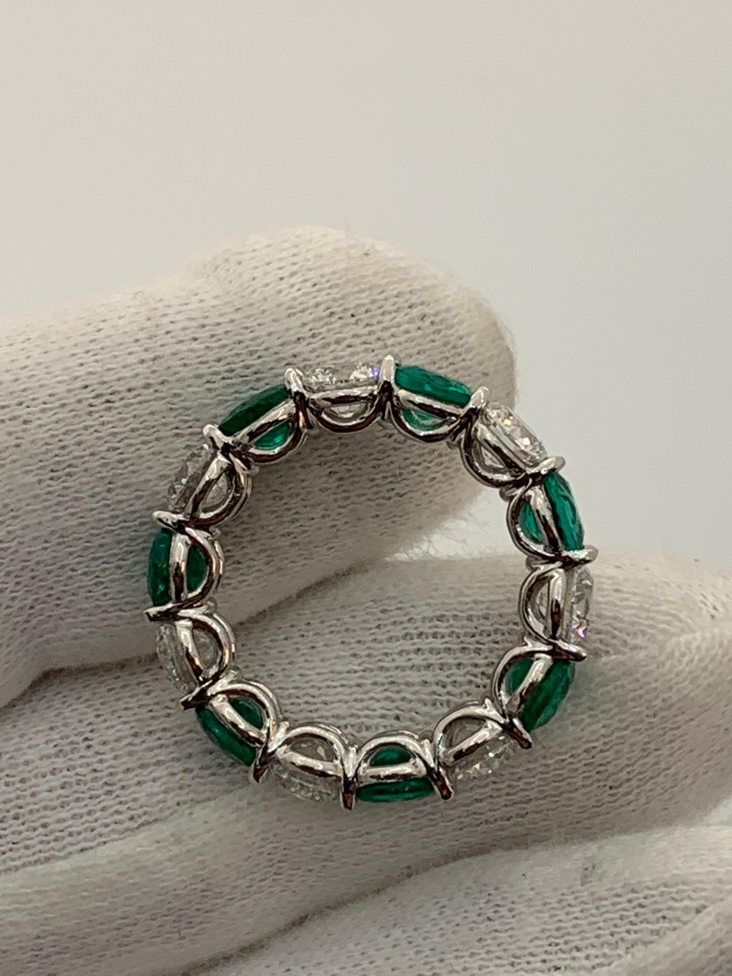Contemporary 6.73 Carat Emerald and Round Diamond Eternity Band Ring For Sale