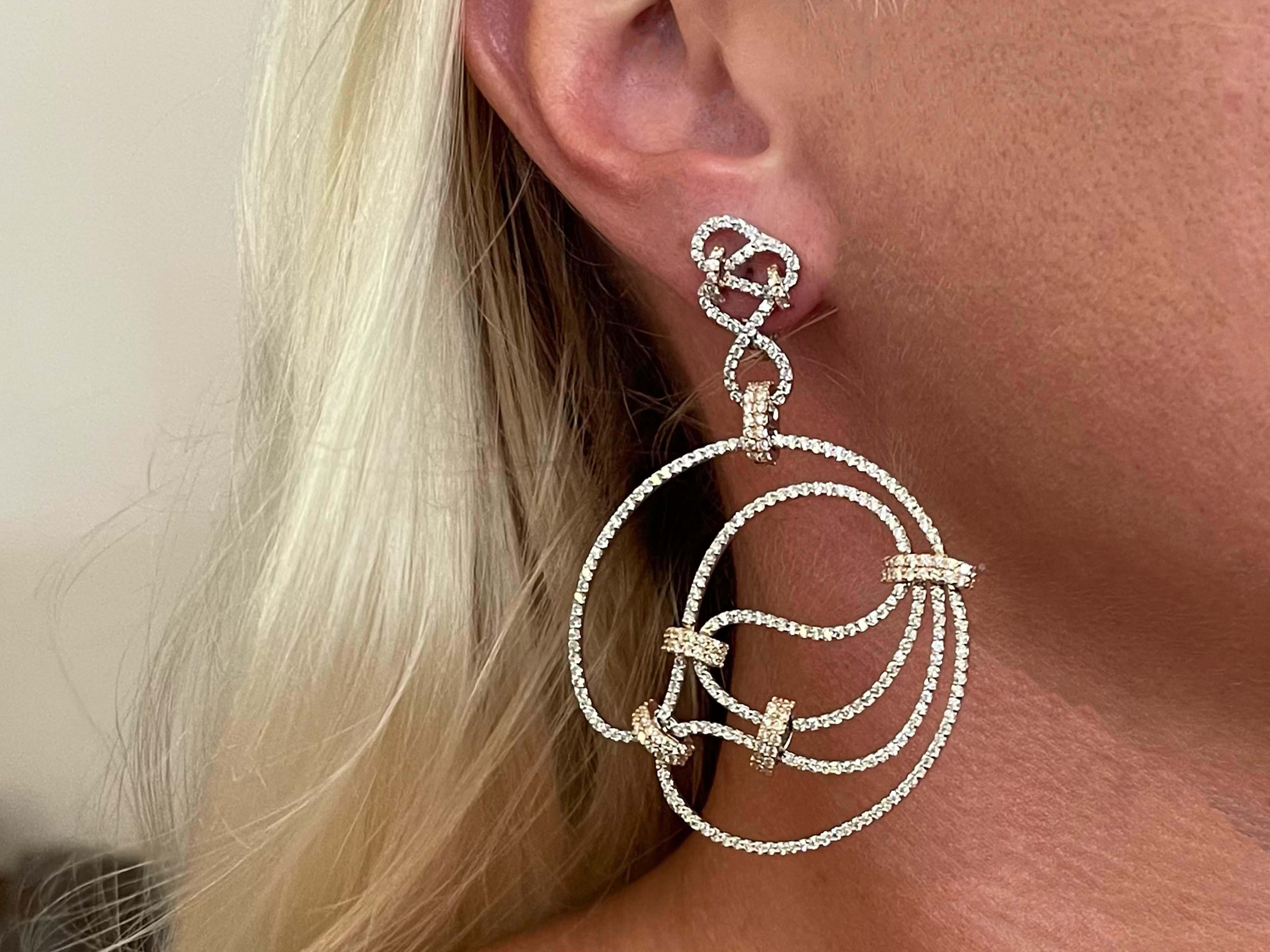 Earrings Specifications:

Metal: 18k White and Rose Gold

Total Weight: 30.6 Grams

Diamonds: 674 White Round Brilliant Cut Diamonds 

Color: G

Clarity: VS

Total Diamond Carat Weight: ~ 6.74 carats 
​
​Stamped: 