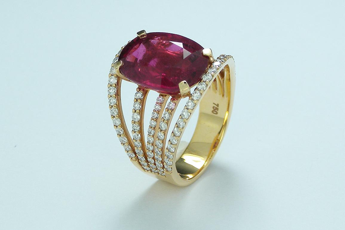 An eye catching cocktail ring, showcasing a fine cushion cut pink tourmaline weighing 6.74 carats and enhanced by pavé-set round diamonds weighing 1.18 total carats (F color/VS1 clarity).

Mounted in Pink Gold 18 karat ( 7.84 gramms ).

Size US