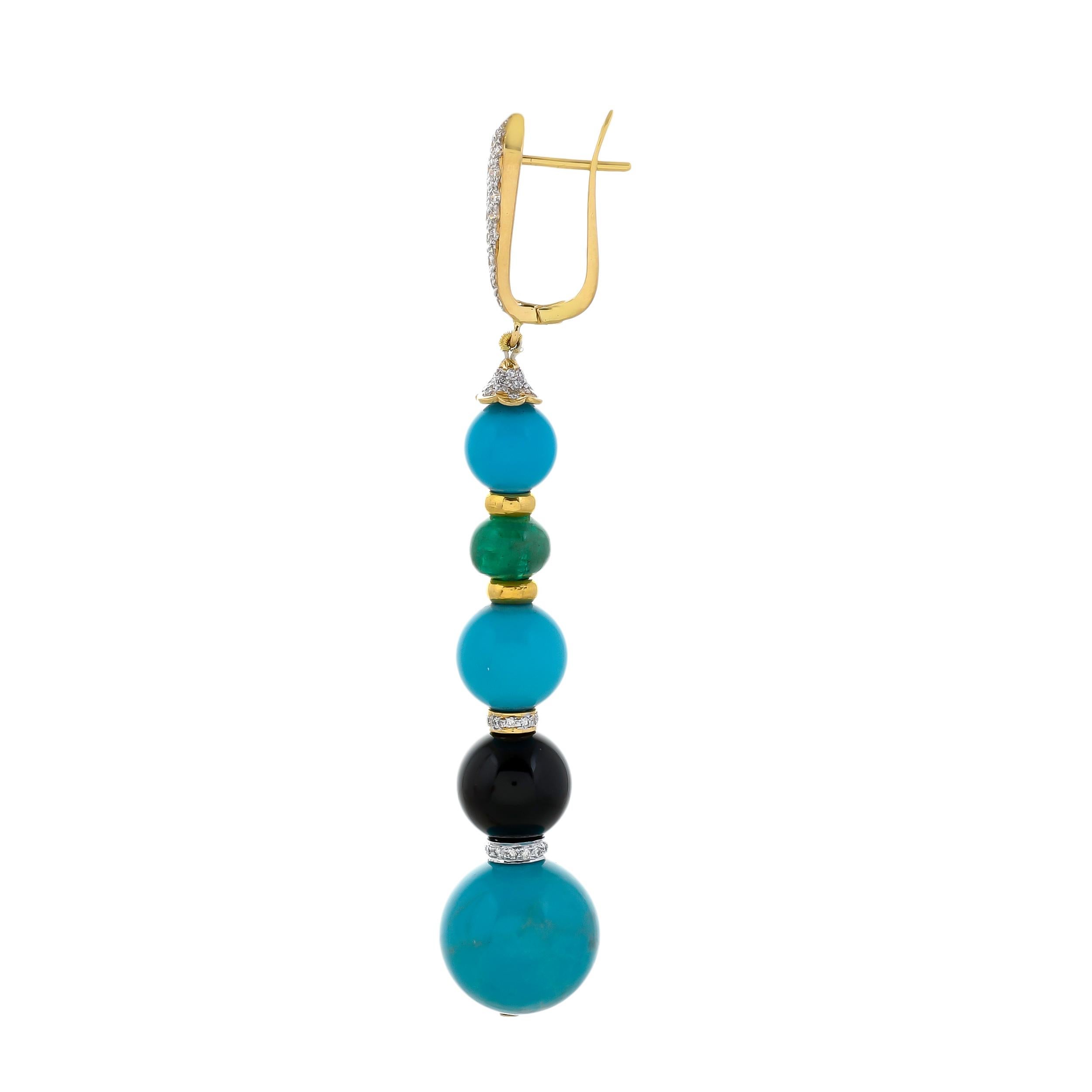 The gorgeous colour palette of gemstones in a one-of-a-kind pair of artisan earrings, hand-crafted in 18kt yellow gold dangle earrings featuring turquoise, black onyx, and emerald beads with a total gemstone weight of 67.40 carats separated by