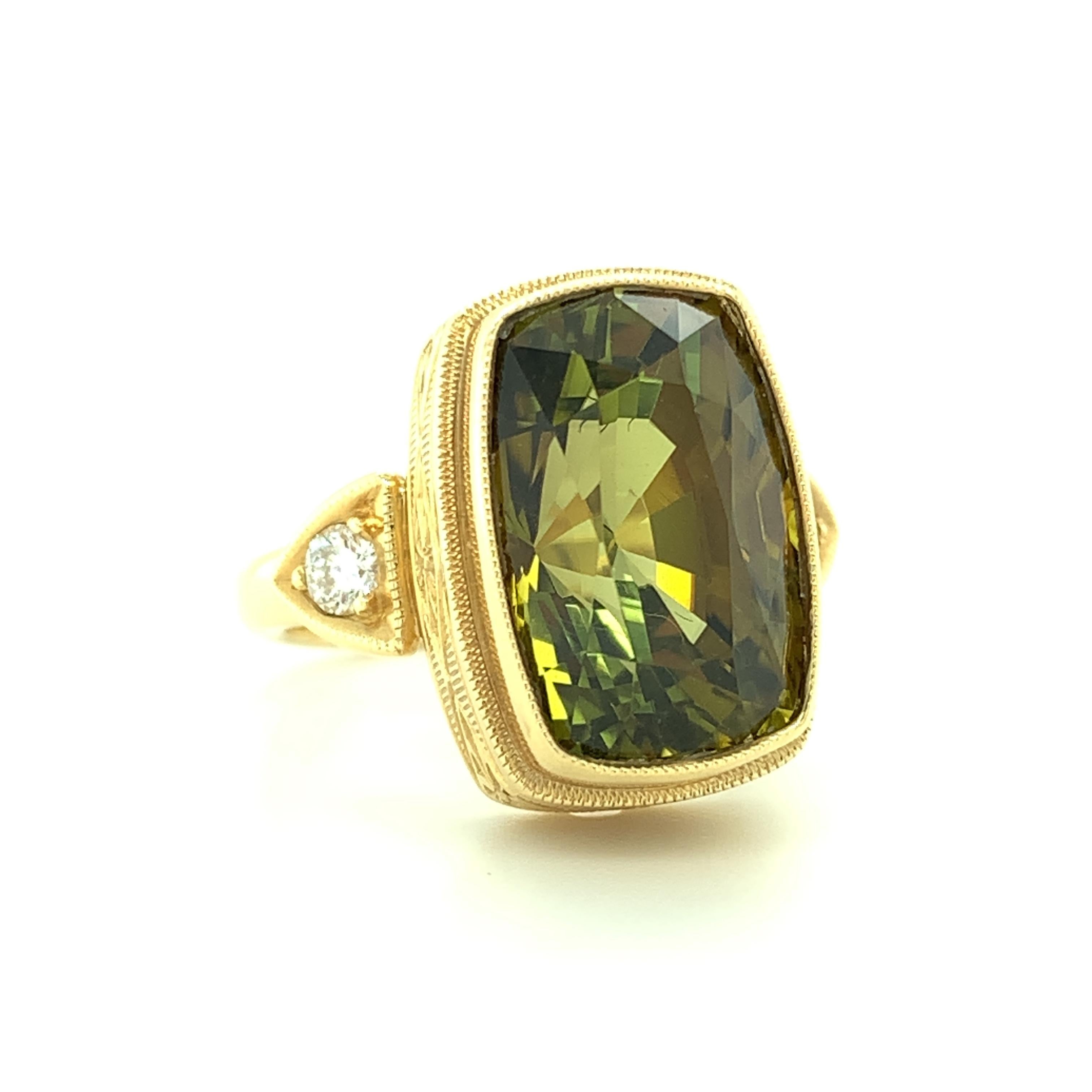 This gorgeous ring features a rich, 6.75 carat, elongated cushion cut olive tourmaline that has been set in a handmade 18k yellow gold bezel. We designed this style to showcase gorgeous gemstones like this one, whose highly polished facets reflect a