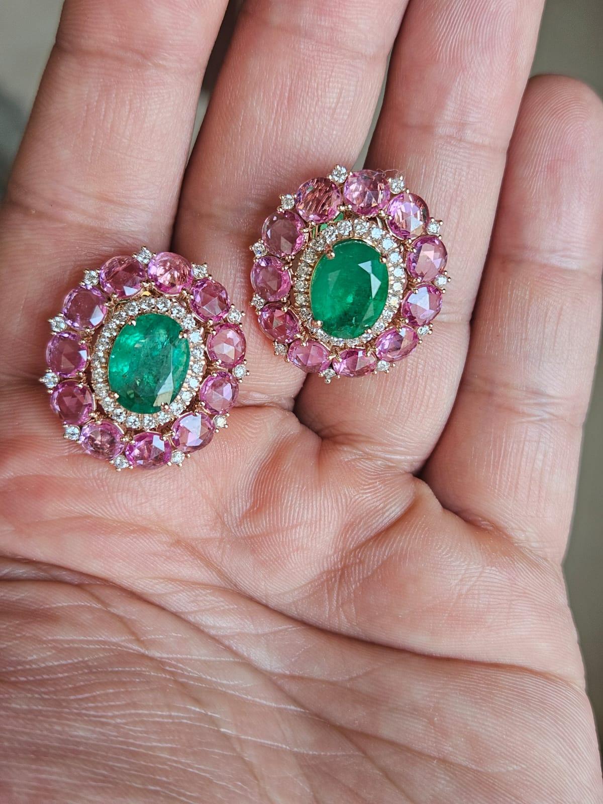 A very gorgeous and beautiful, modern style, Emerald & Pink Sapphires Stud Earrings set 18K Gold & natural Diamonds. The weight of the oval shaped Emeralds in 6.75 carats. The Emeralds are completely natural, without any treatment and are of Zambian