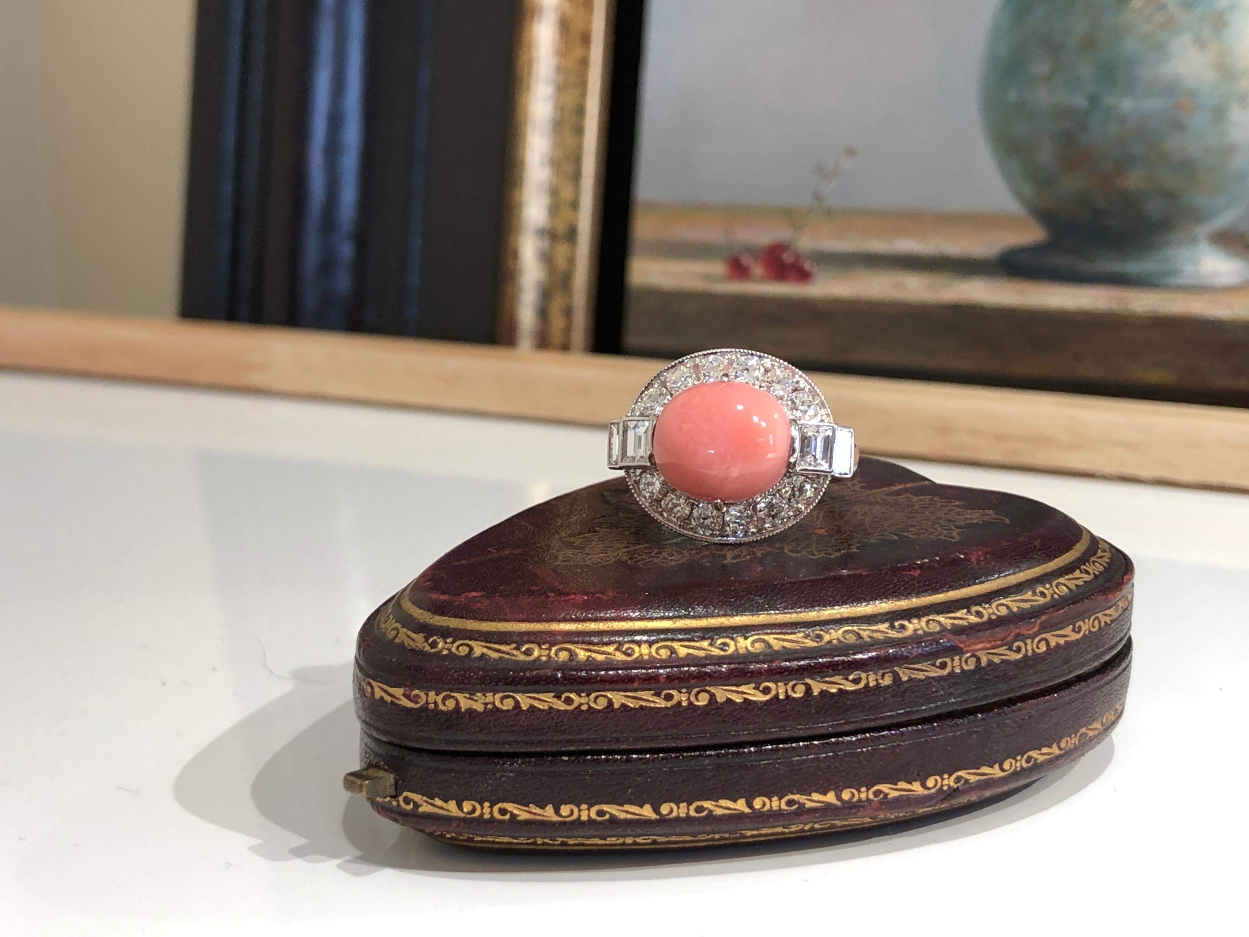 A beautiful and rare natural conch pearl set in a diamond cluster mounting. Conch pearls are very rare and highly collectable, particularly ones that are pink. The central conch pearl in this ring has a lovely baby pink colour with a visible flame