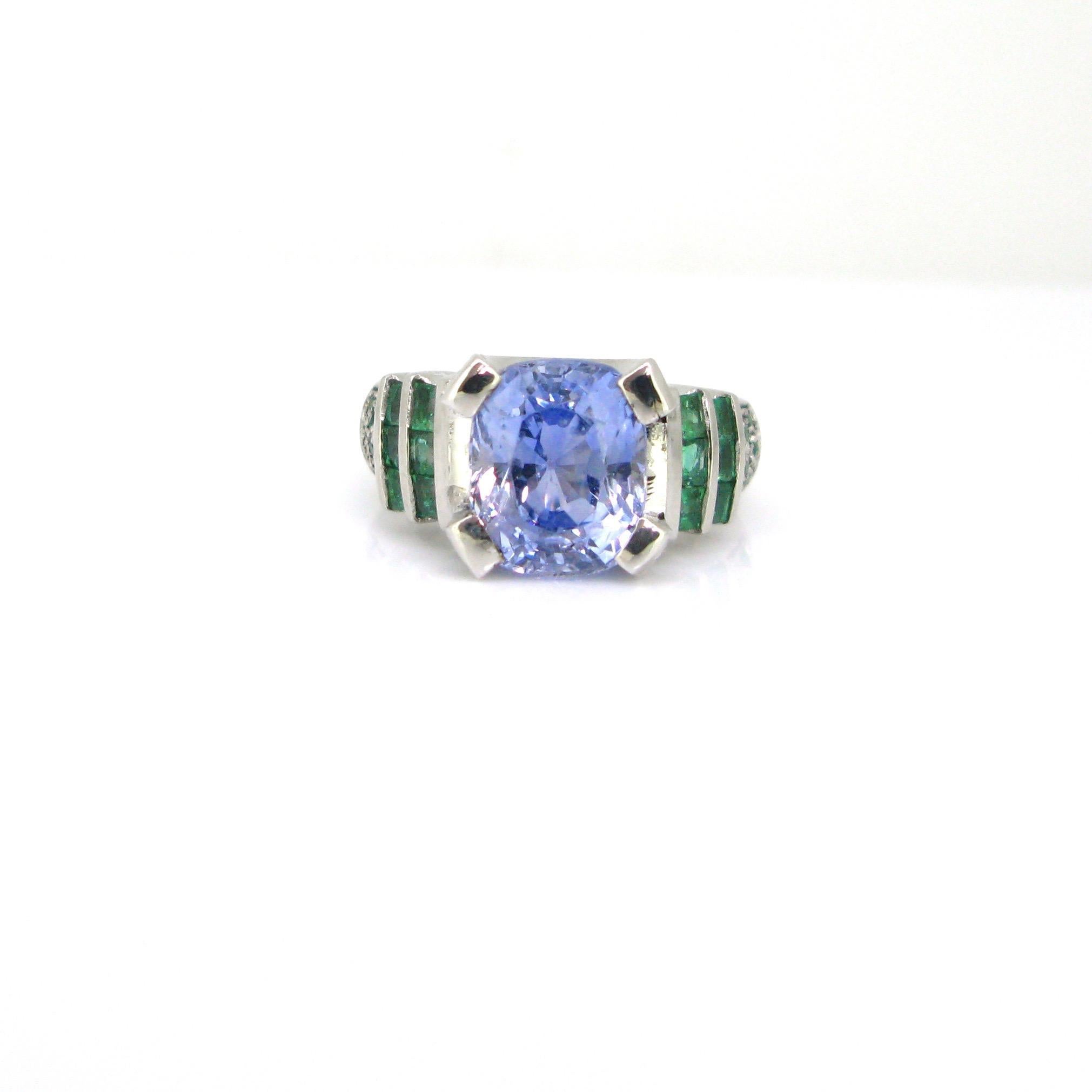 Weight:	14,29gr

Metal:	18kt white Gold

Stones:	1 Sapphire
•	Cut:	Cushion
•	Carat:	6,75ct
•	Origin:	Ceylon (Sri Lanka)
•	Comments:	No indication of heating

Others:	44 Emeralds
•	Cut:	32 Round cut – 12 Square cut
•	Total Carat Weight:	0.80ct