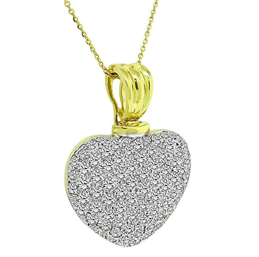 This is an elegant 14k yellow and white gold heart pendant necklace. The pendant is set with sparkling round cut diamonds that weigh approximately 6.75ct. The color of these diamonds is H-I with VS clarity. The pendant measures 42mm by 32mm while