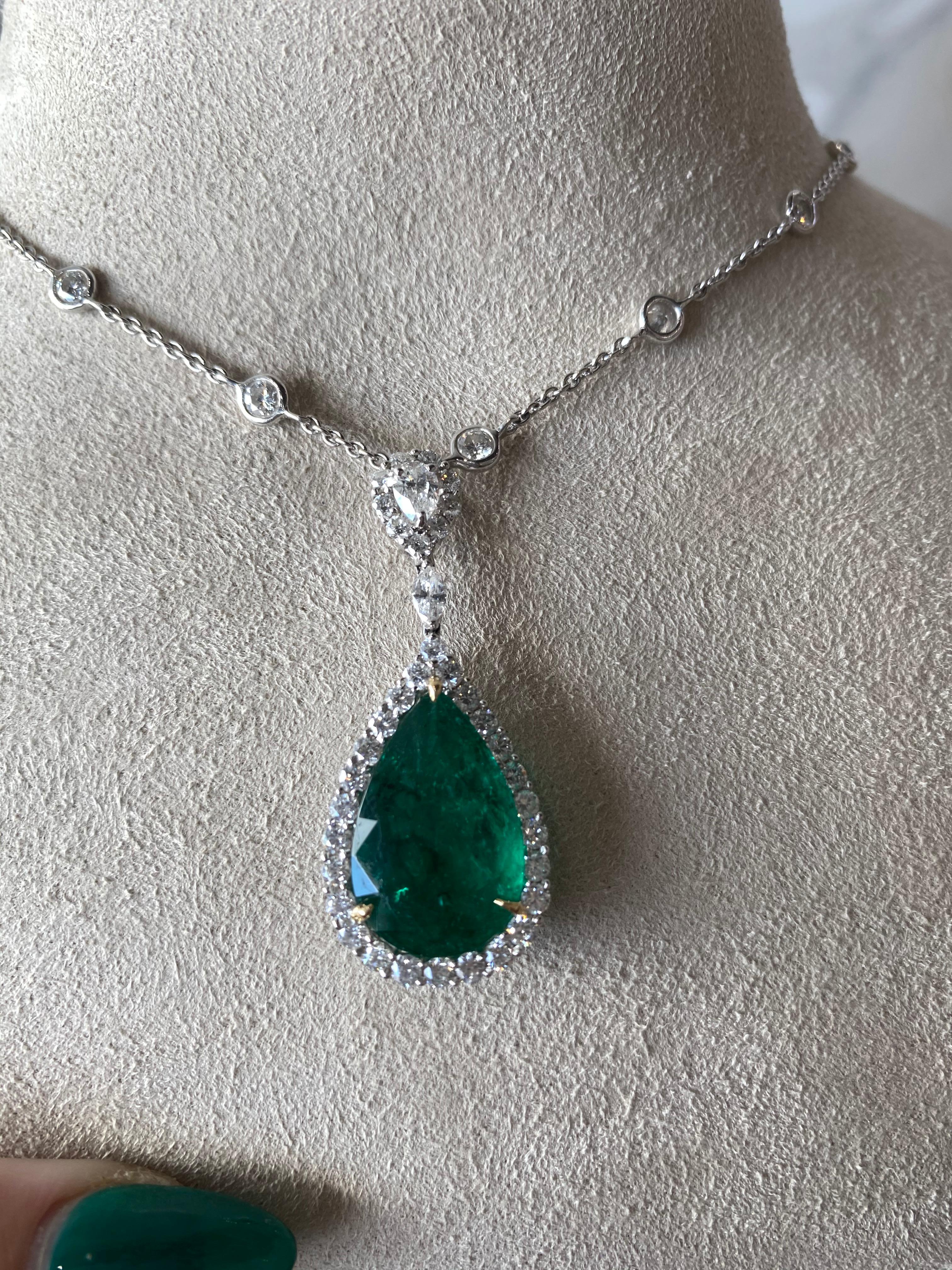 This exquisite necklace seamlessly blends the more classic style of a diamonds-by-the-yard style necklace featuring 3.82ct total weight in round diamonds and the more regal style of a 6.75ct pear shaped emerald, surrounded by a round diamond halo.
