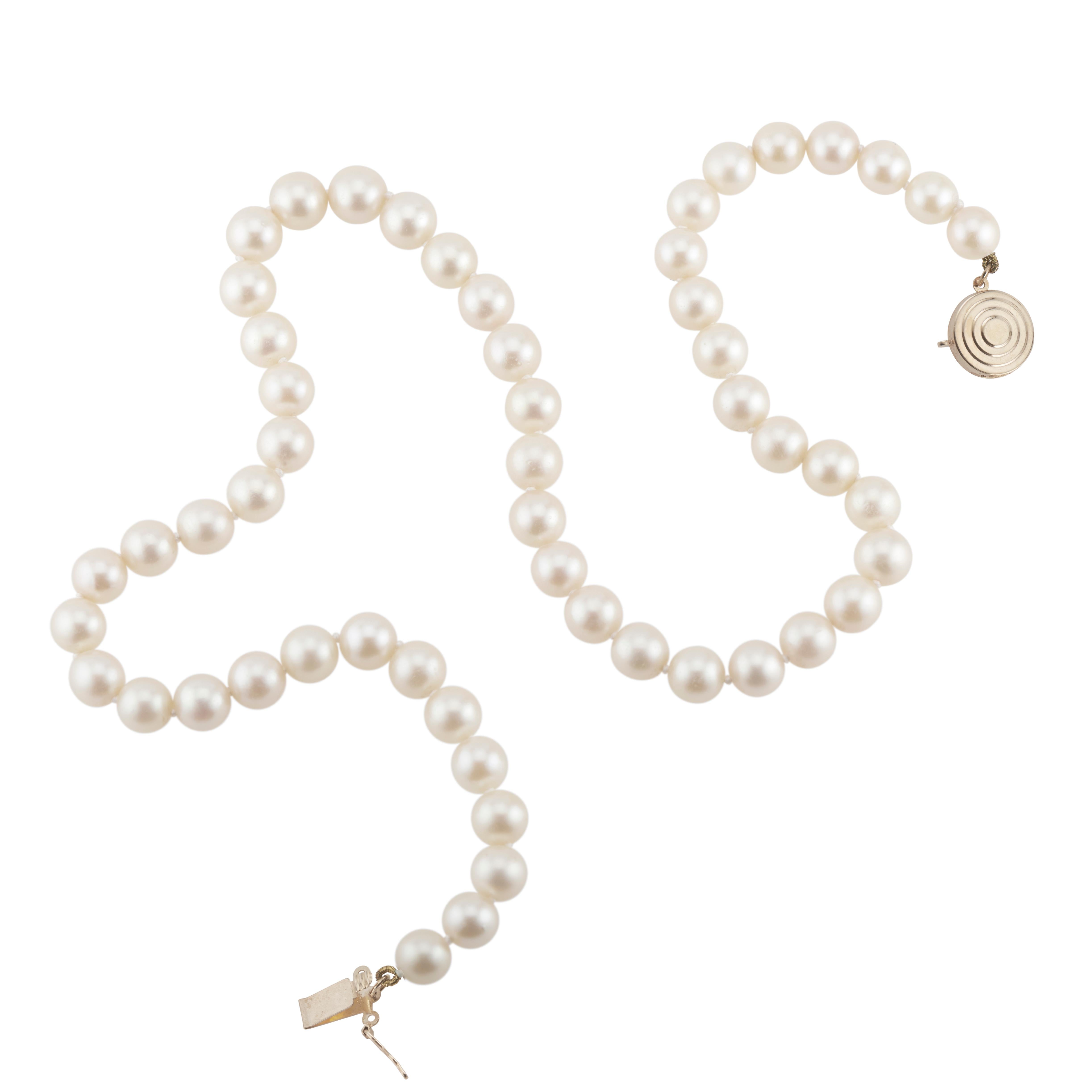 28-Inch-long cultured pearl necklace, white with creme and light pink overtones, few blemishes, good lustre. 90 Freshly strung pearls. Just a note, this strand of pearls does have knots in between each pearl. They are visible in the last picture