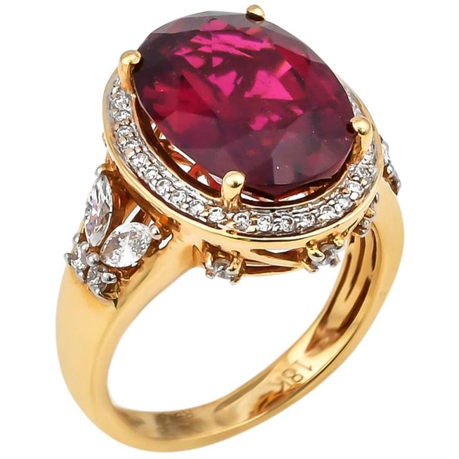6.77 Carat Oval Shaped Rubelite Ring in 18 Karat Yellow Gold with Diamonds For Sale
