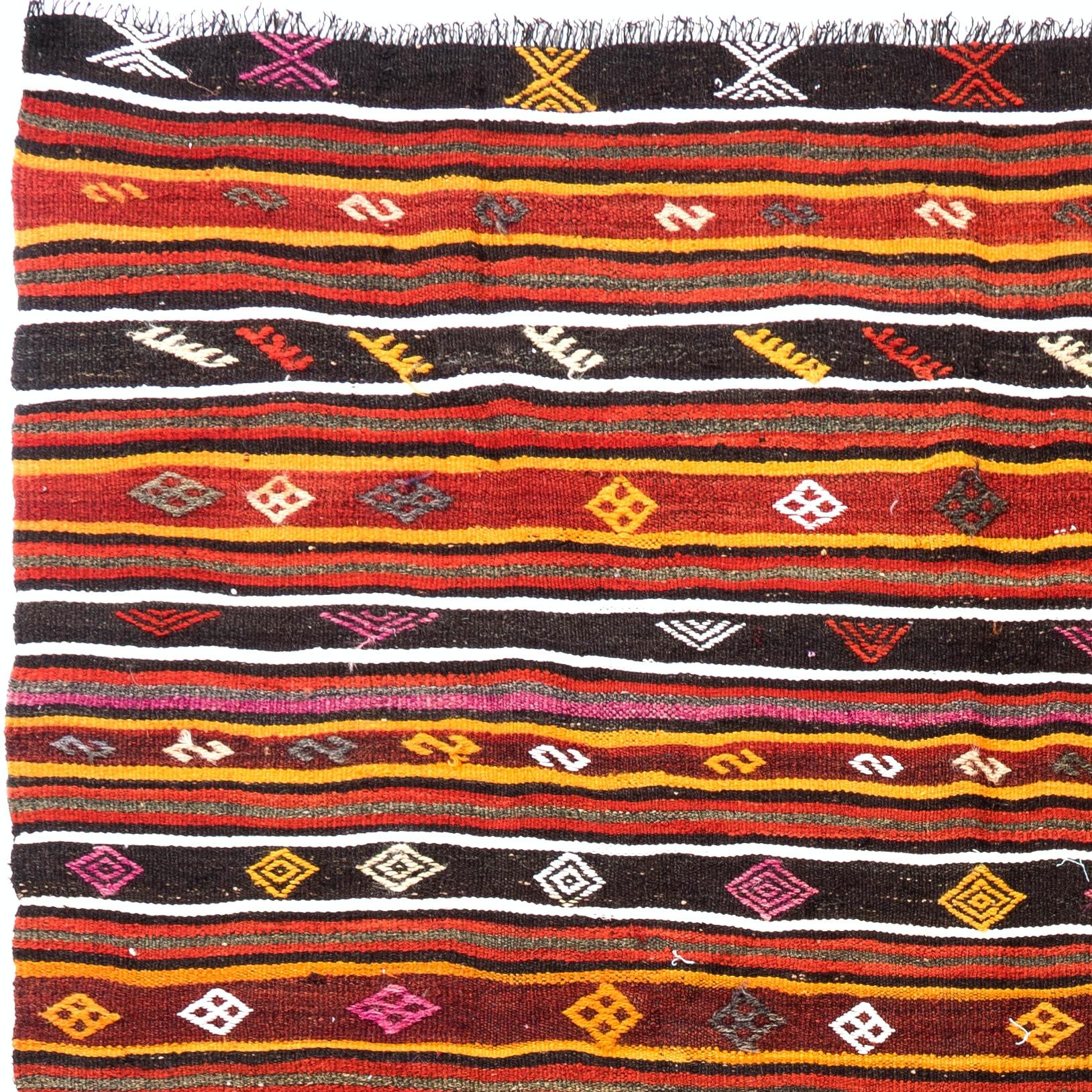 A dazzling Turkish Kilim (double sided flat-woven rug) in excellent original condition. It is finely handwoven and made of wool with white cotton highlights. Measures: 6.7 x 10 Ft.