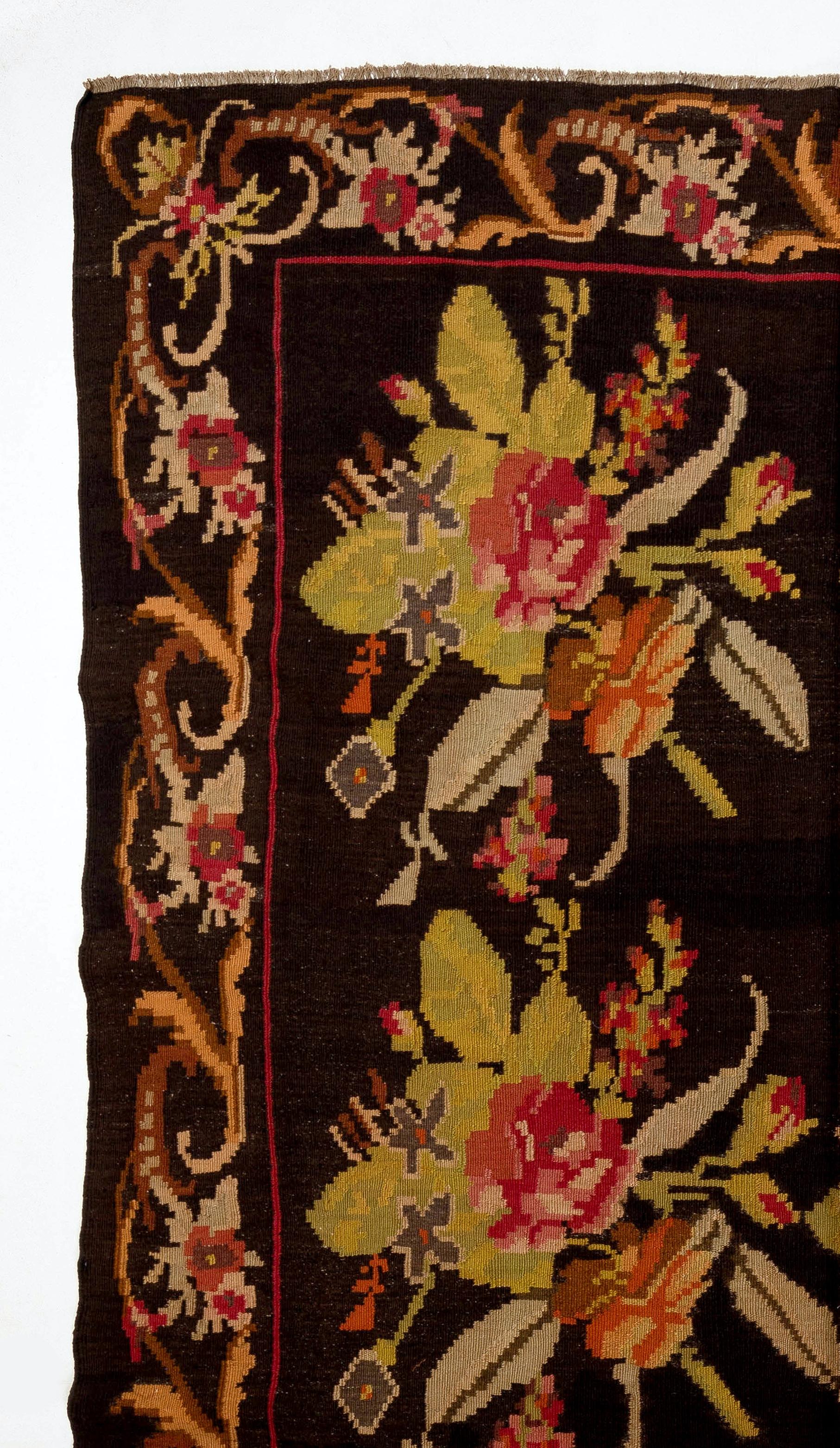 One of a kind vintage Bessarabian Kilim. Size: 6.7x11.8 ft
A handwoven Eastern European rug from Moldova. These traditional Moldovan flat-weaves are inspired from vintage Aubusson carpets but they are distinguished with their black grounds, large