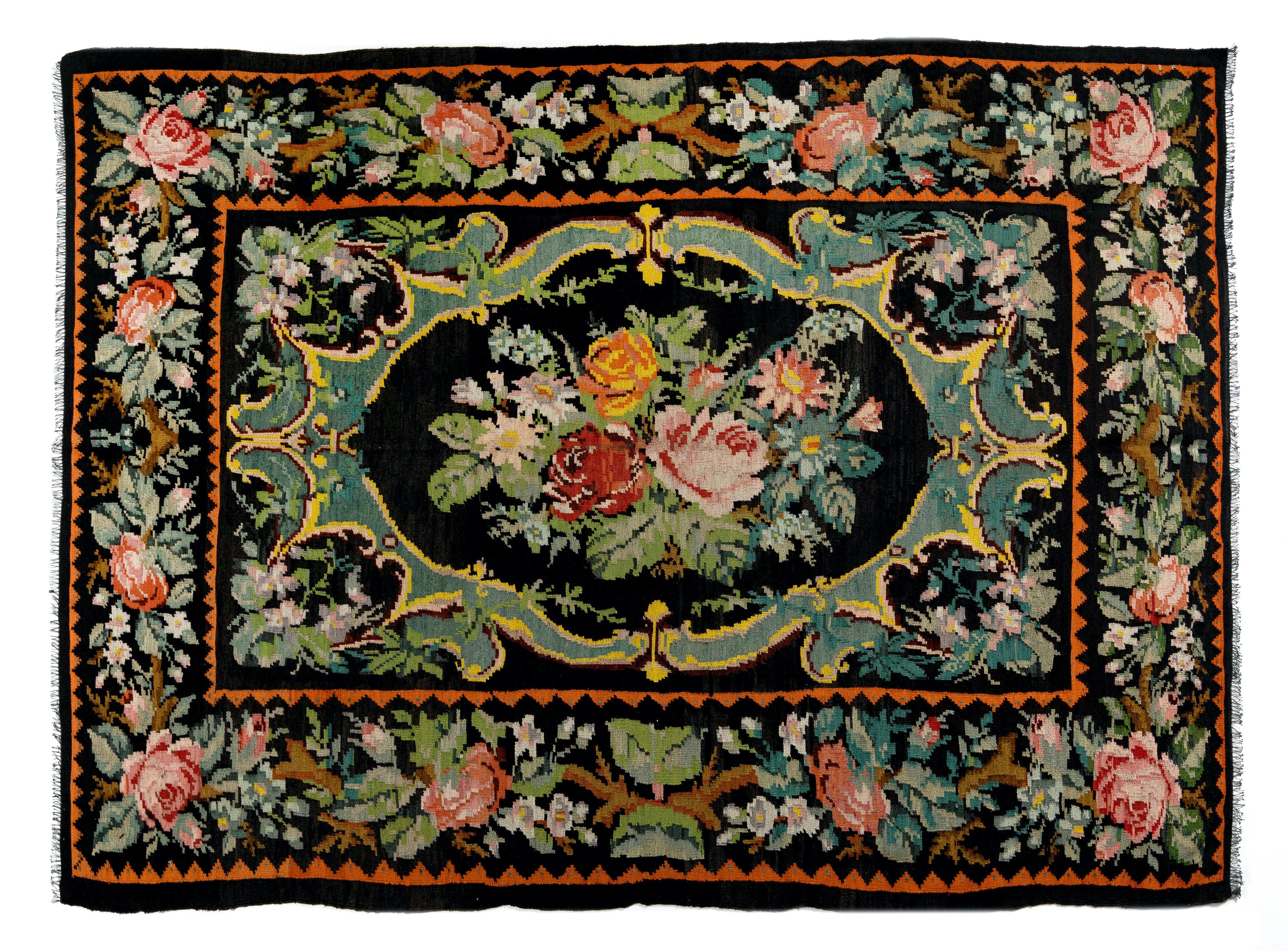 One of a kind vintage Bessarabian Kilim.
A handwoven Eastern European Rug from Moldova. These traditional Moldovan flat-weaves are inspired from vintage Aubusson carpets but they are distinguished with their black grounds, large floral patterns in