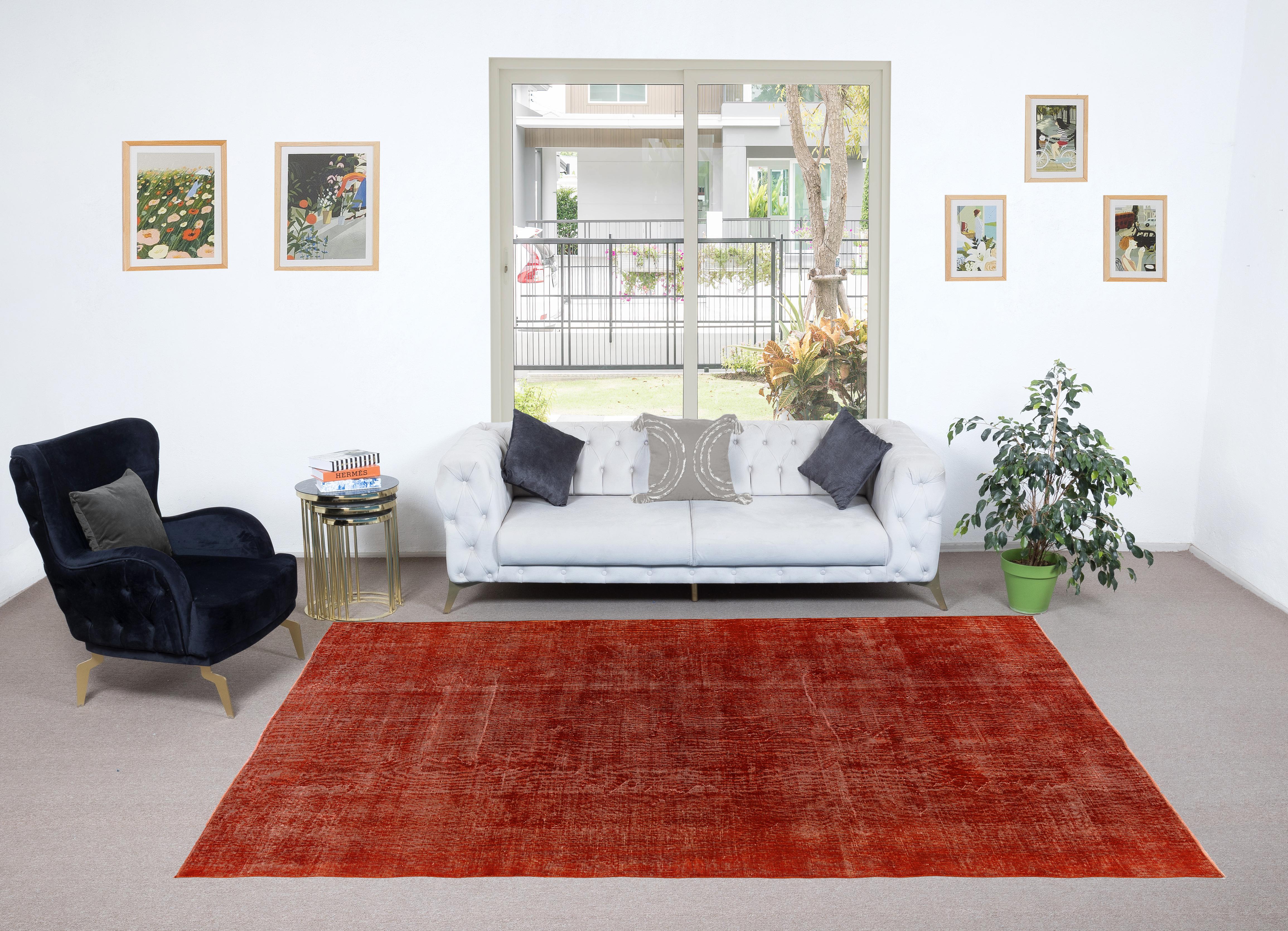 A vintage Turkish area rug re-dyed in burnt orange color for contemporary interiors.
Finely hand knotted, low wool pile on cotton foundation. Professionally washed.
Sturdy and can be used on a high traffic area, suitable for both residential and