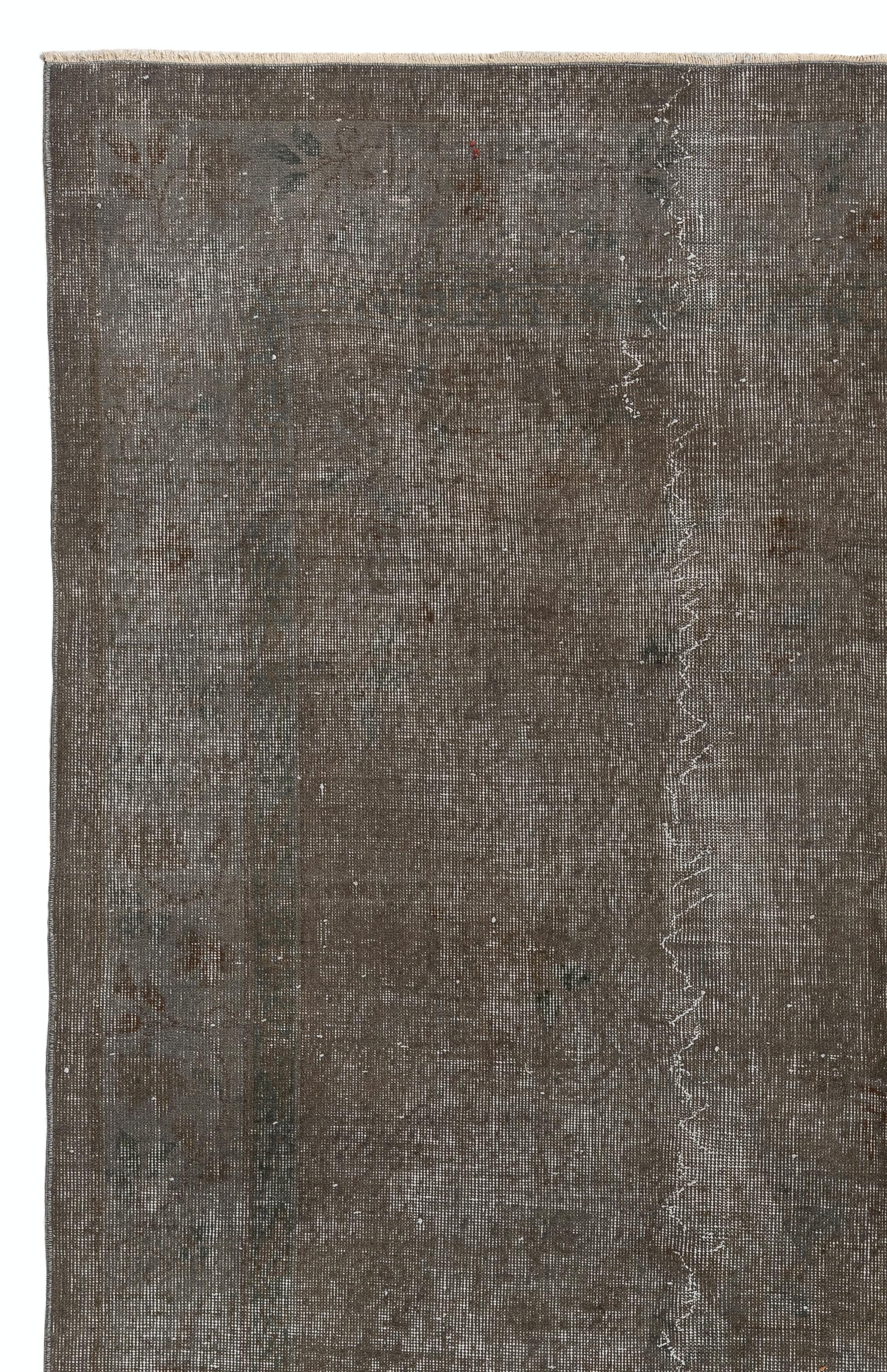 A vintage Turkish area rug re-dyed in gray color for contemporary interiors. Measures: 6.7 x 10 Ft.
Finely hand knotted, low wool pile on cotton foundation. Professionally washed.
Sturdy and can be used on a high traffic area, suitable for both