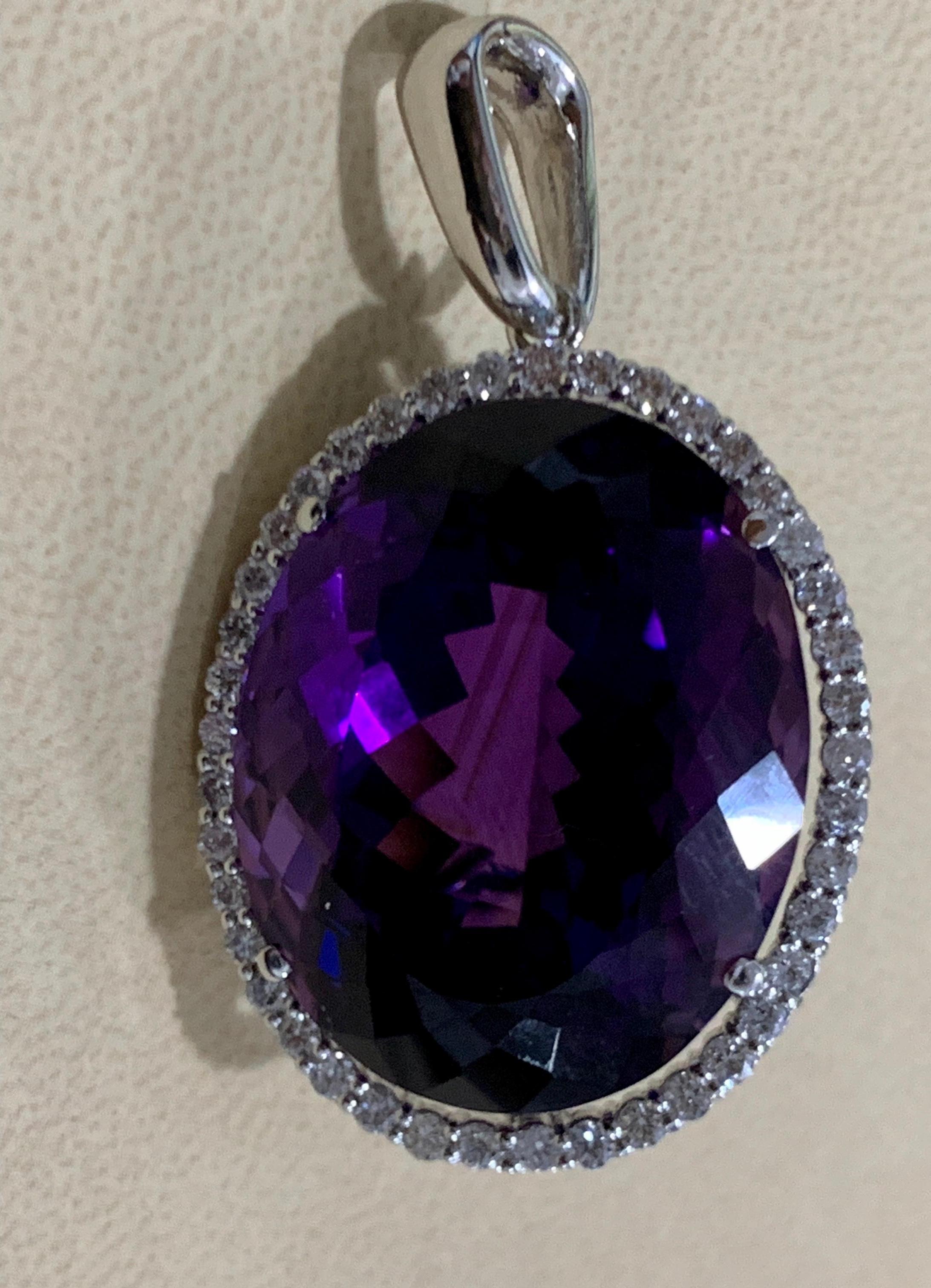  Approximately   68 Carat Amethyst & 2.2 ct Diamond Pendant Necklace 14 Karat White Gold + Chain
This spectacular Pendant Necklace  consisting of a single large Oval Amethyst , approximately  68 Carat.  The  Amethyst   Has Circle of diamonds around