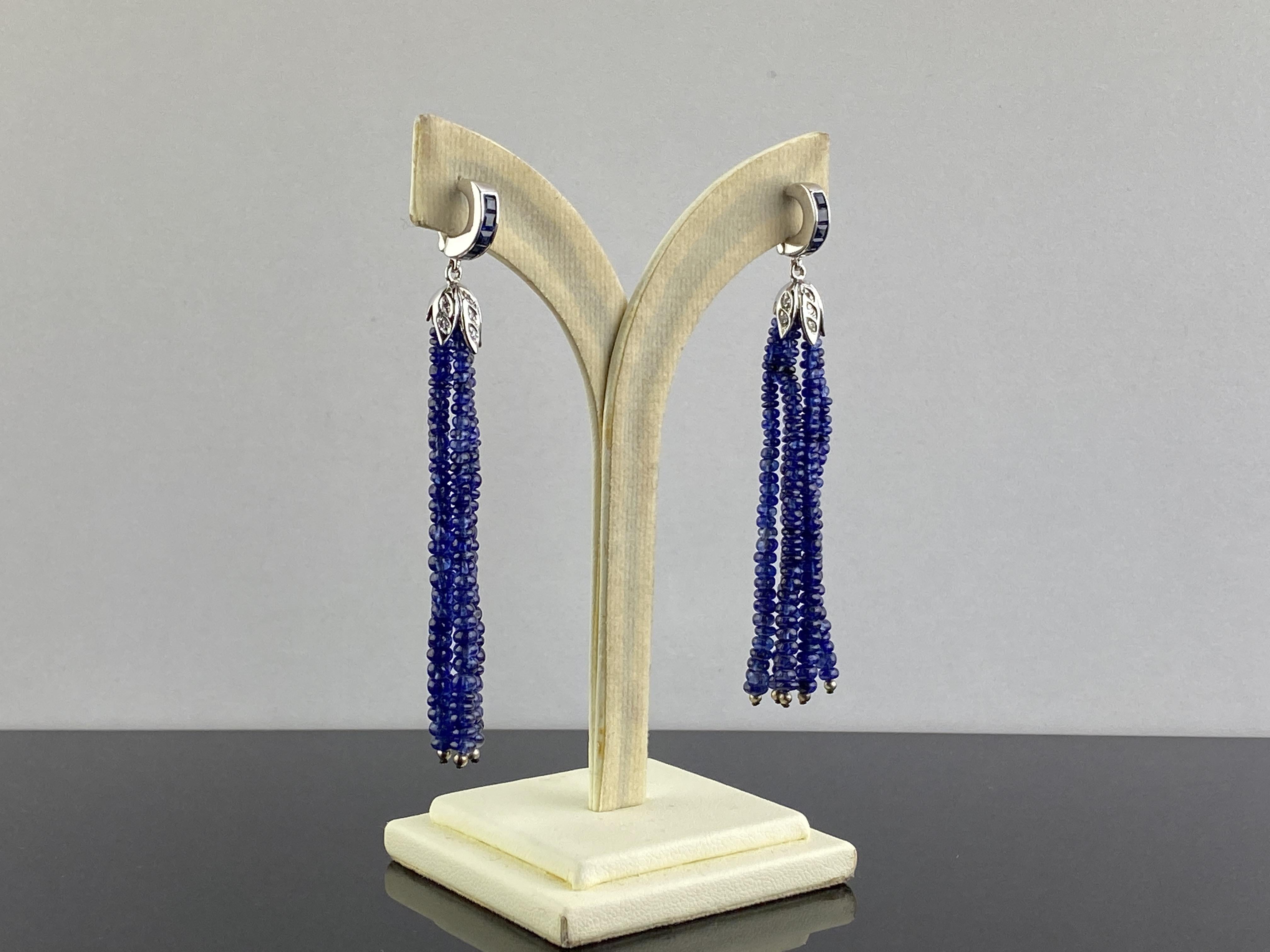 A beautiful pair of dangling earrings, with 68 carats Blue Sapphire beads earrings, set in 18K White Gold with Diamonds and Blue Sapphires. The earrings come with a push-pull backing, and are around 3 inches long. Please feel free to message fore