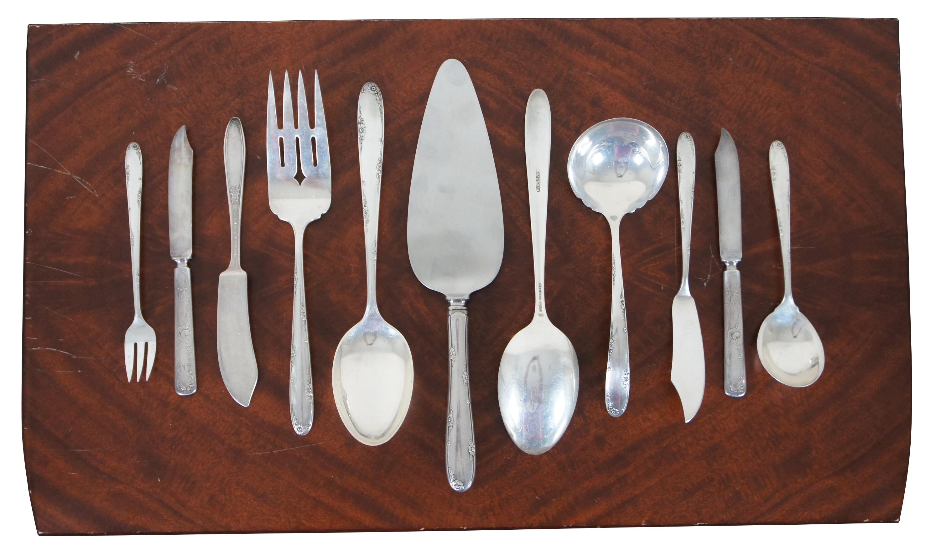 1948 Towle Sterling 68 piece flatware set and wood storage chest in the Madeira pattern, subtly monogrammed with a K. Includes three non-matching silver plate pieces from R. Wallace and Lady Doris.

Measures: Chest - 19.75” x 12” x 3.75” / 8 Table