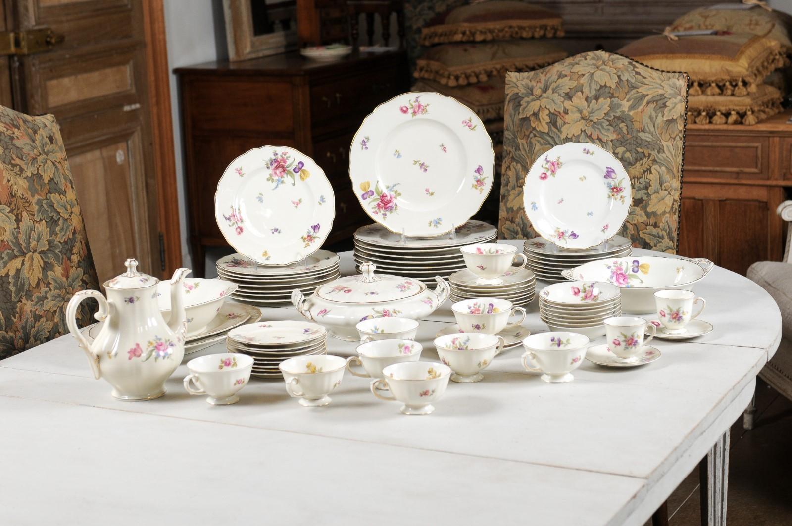 A set of 68-piece floral Franconia Selb Bavaria dining set from the mid 20th century, with pink, purple, blue and yellow flowers among others. Created in Germany during the second quarter of the 20th century, this set of porcelain dishes captures