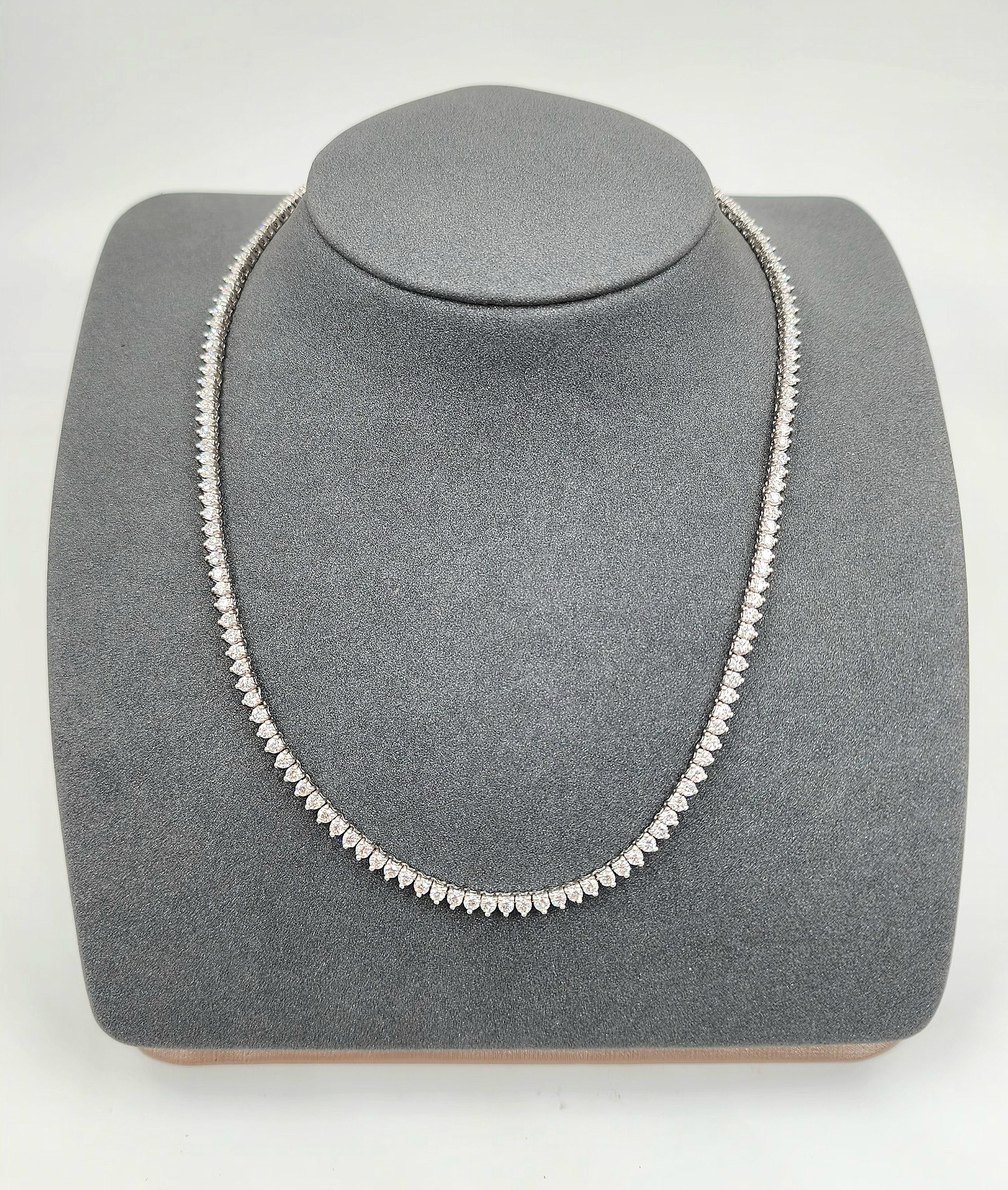 This necklace showcases a sleek design with a continuous line of 160 diamonds. The primary stones are round cut, totaling 6.81 carats,VS1/VS2 in clarity, and F/G in color grade. Crafted in platinum, this modern piece measures 16 inches in length. A