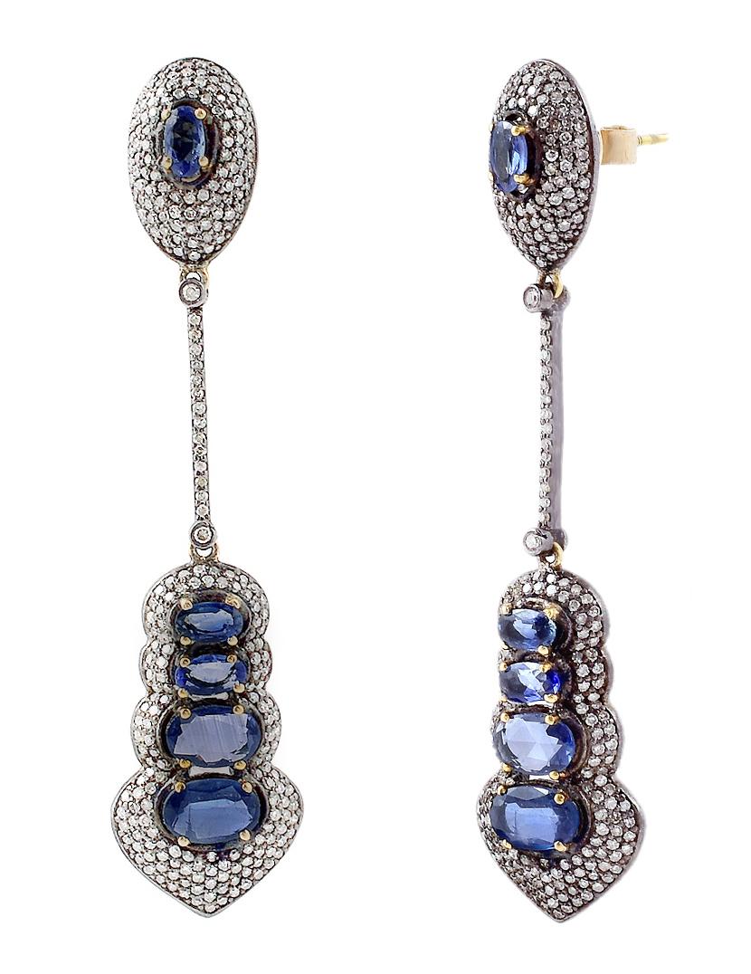 6.82 Carat Blue Sapphire and Diamond Dangle Earrings in Victorian Style

This Victorian style cobalt blue sapphire and diamond long earring is incredible. The bottom graduating oval sapphires are complemented with a beautiful pave diamond cluster.