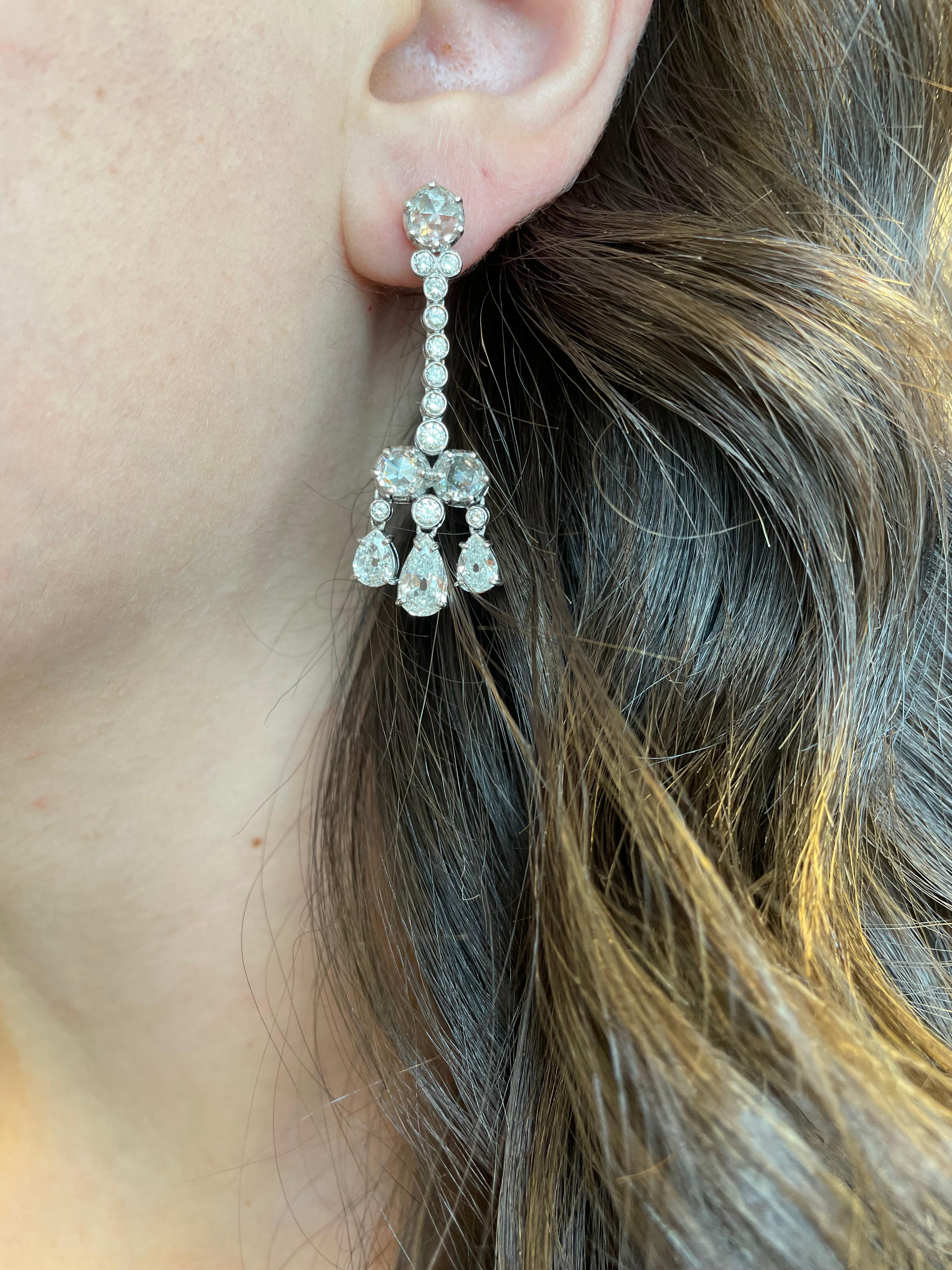 Lovely dangling multi shape diamond chandelier earrings.
6.82 carats of pear, rose cut, and round cut diamonds.  Approximately G/H color and VS2/SI1 clarity. 18-karat white gold.
Accommodated with an up to date appraisal by a GIA G.G. upon request.