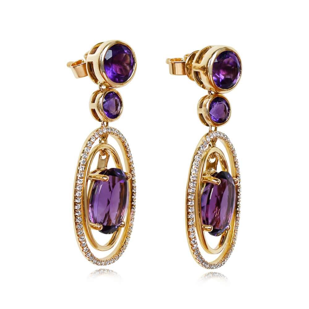 Experience the perfect blend of elegance and geometry with these mesmerizing earrings. Crafted with precision, these geometric wonders showcase oval-cut amethysts delicately set in prongs, creating a captivating focal point. Suspended within dual