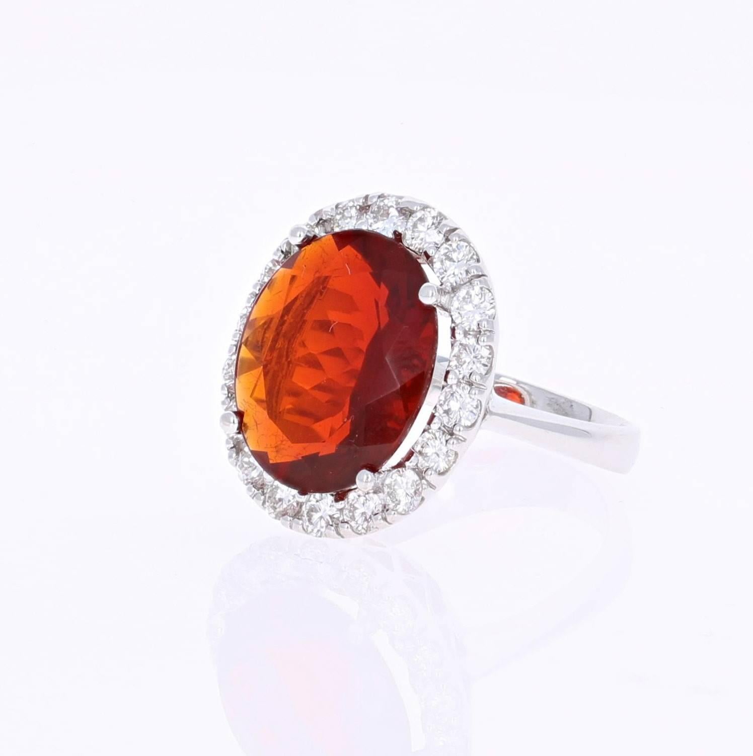 Beautiful Fire Opal and Diamond Ring. This ring has an Oval Cut 5.71 carat Fire Opal in the center of the ring and is surrounded by a halo of 18 Round Cut Diamonds that weigh a total of 1.15 carat (Clarity: VS2, Color: H).  The total carat weight of
