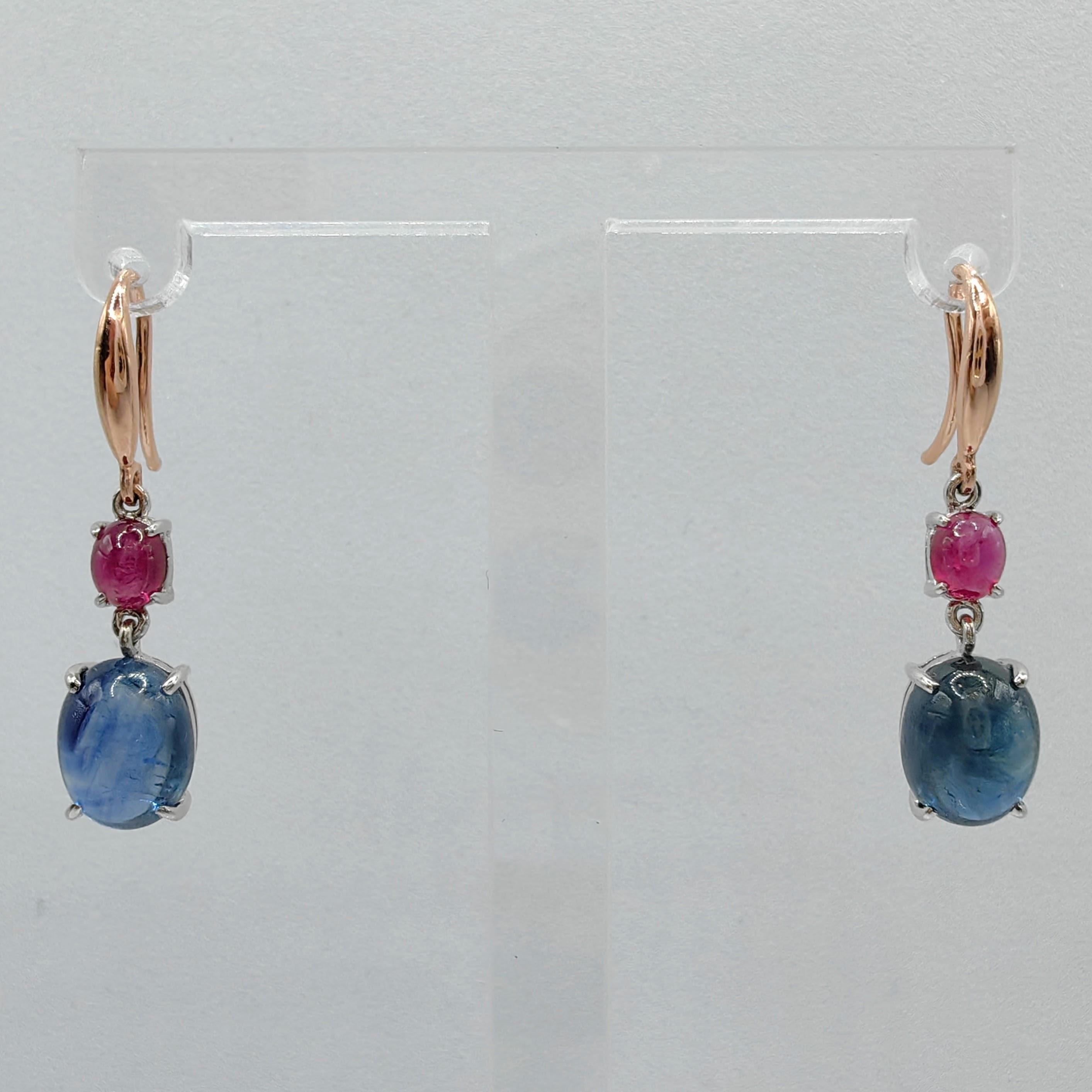 Introducing our exquisite 6.85ct Cabochon Sapphire Ruby Dangling Earrings in 18K Two-tone Rose & White Gold, a mesmerizing fusion of color and elegance that will elevate your style to new heights.

These stunning earrings feature a pair of