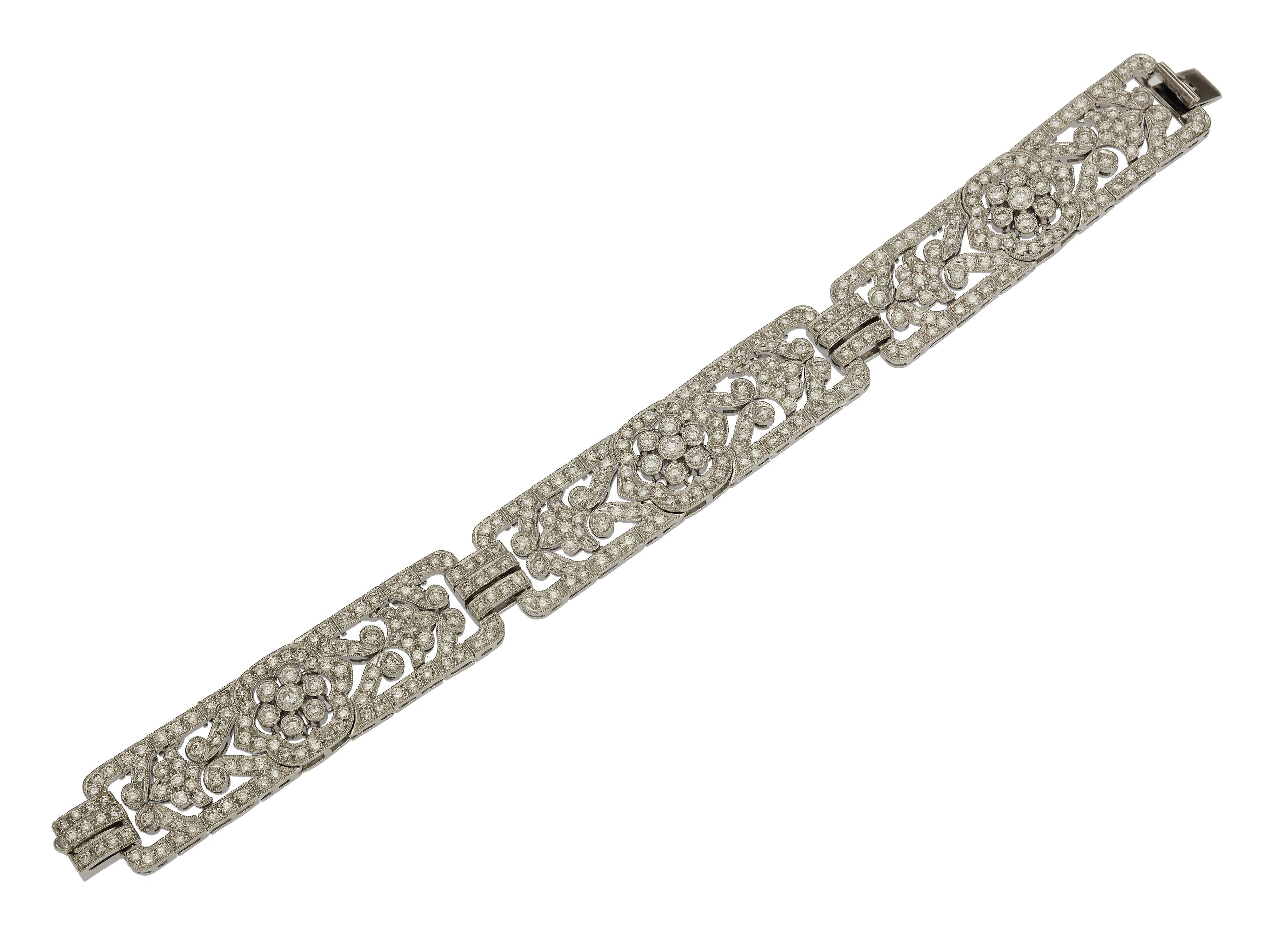 New Elegant 18 Karat White Gold Diamond Bracelet. The Vintage Inspired Design is Arranged in a 3 Piece Flower Pattern with Milgrain Detail on the Metal Edges. Prong and Bezel Set Round Brilliant Cut Diamonds of SI Clarity & H Color Total 6.86