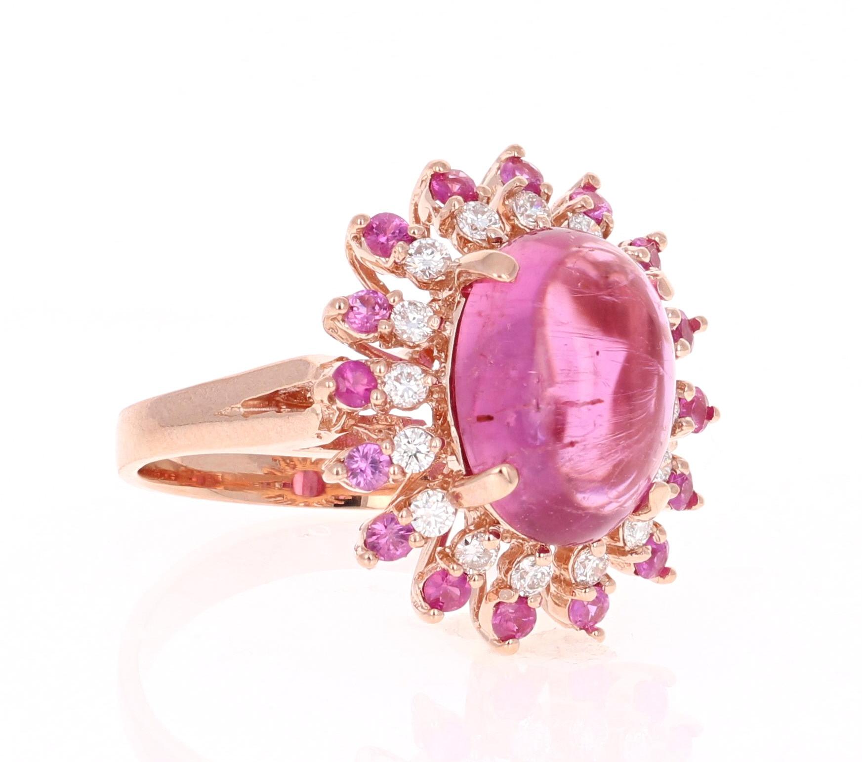 Stunning and uniquely designed 6.86 Carat Pink Tourmaline, Pink Sapphire and Diamond Rose Gold Cocktail Ring! 

This ring has a 5.86 carat Oval Cut Cabochon Pink Tourmaline that is set in the center of the ring and is surrounded by 16 Round Cut